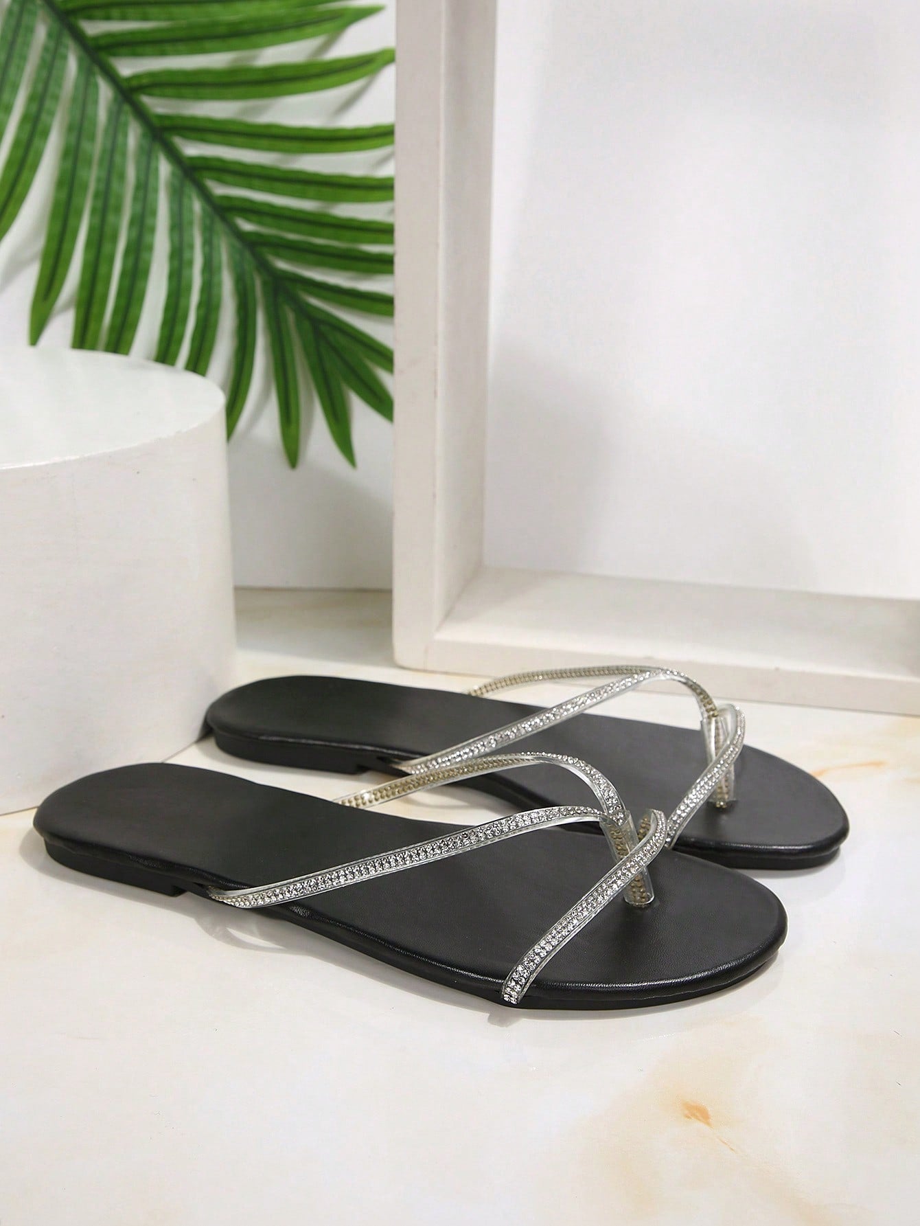 Plus size women's black flat thong sandals with rhinestone detail, round open toe, and slip-on beach-style design