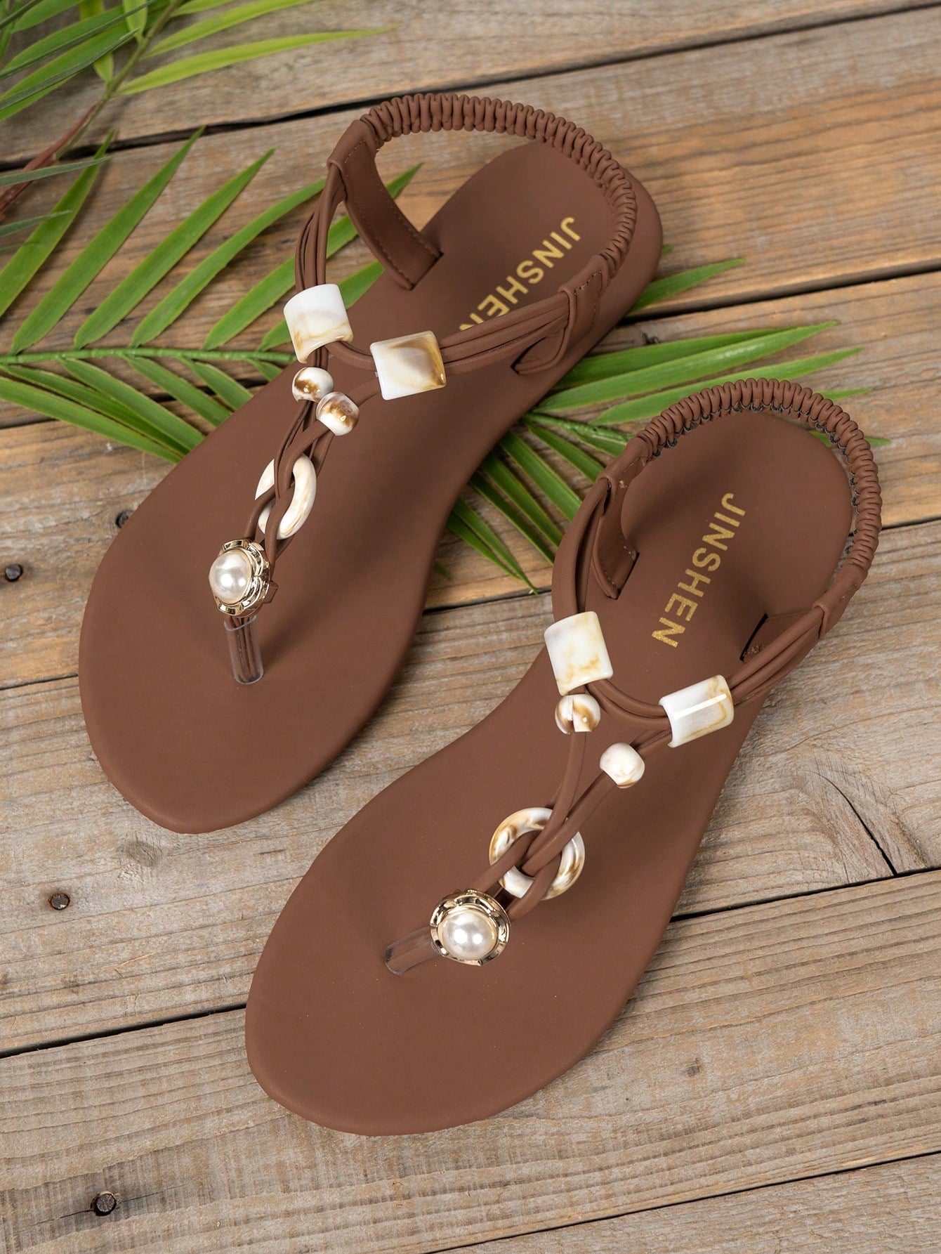 Women's beaded woven flip flop thong sandals with flat soft sole, toe-post design, and beach-style plant pattern detailing.