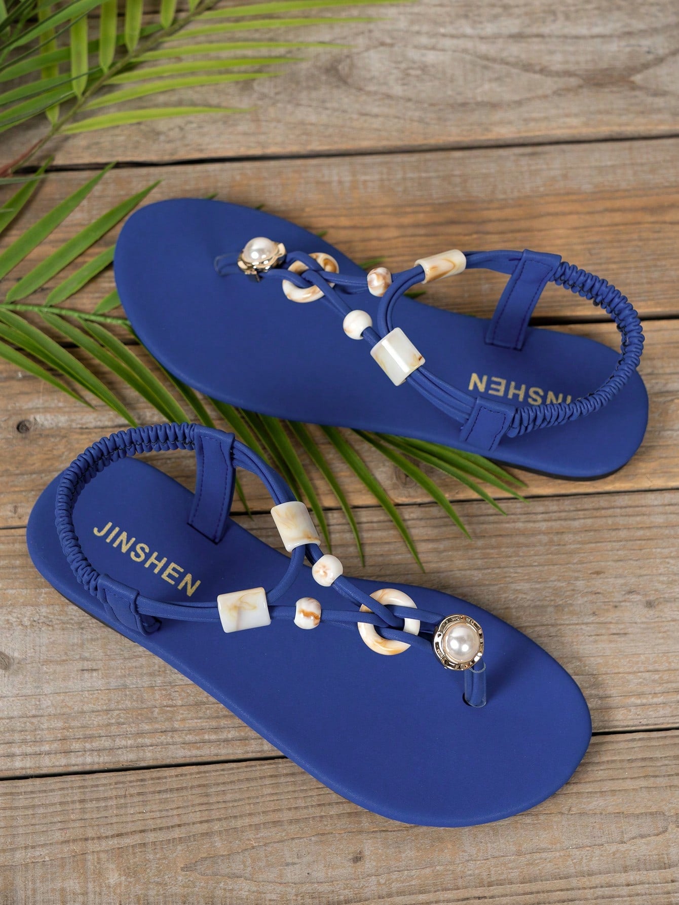 Women's beaded woven flip flop thong sandals with flat soft sole, toe-post design, and beach-style plant pattern detailing.