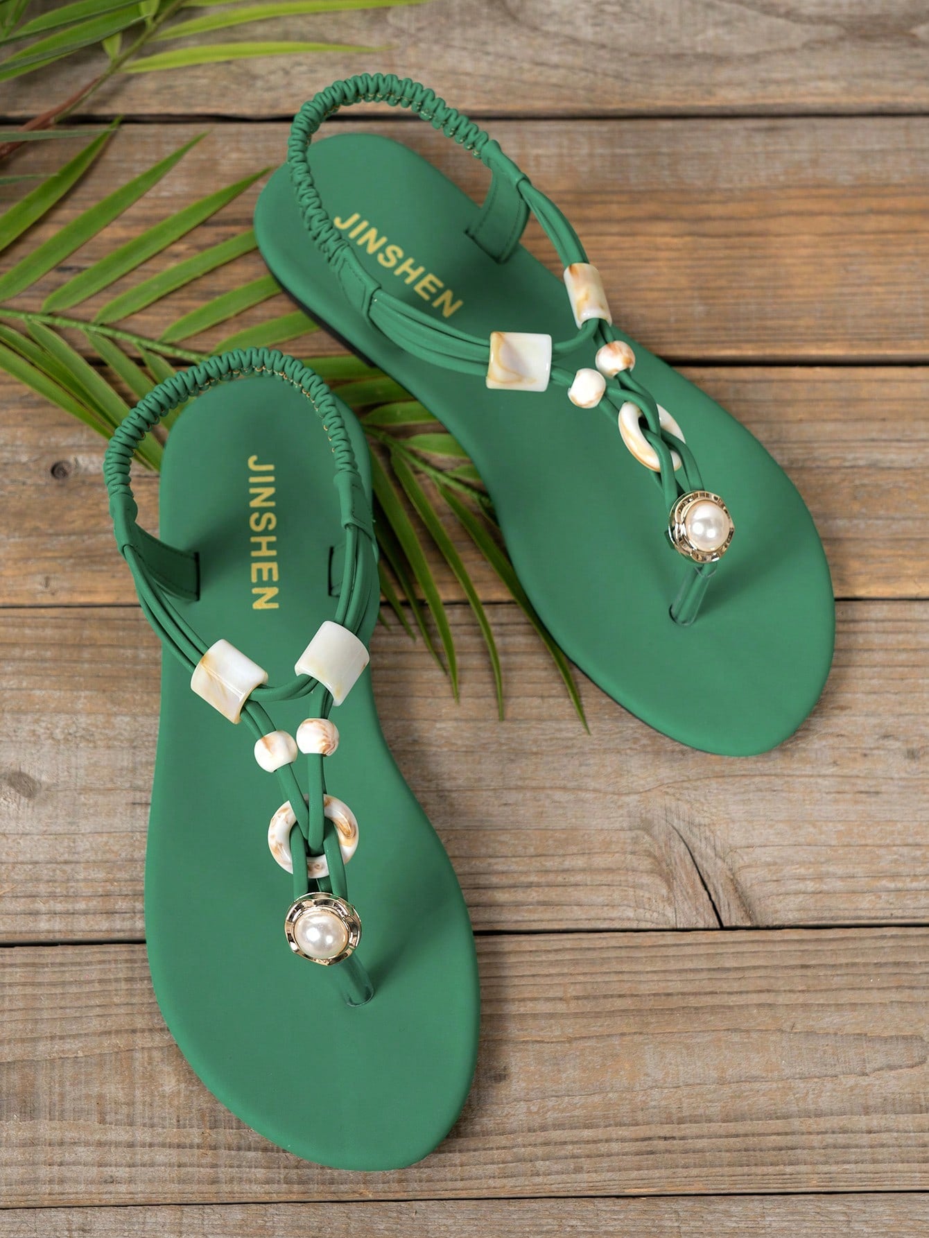 Women's beaded woven flip flop thong sandals with flat soft sole, toe-post design, and beach-style plant pattern detailing.