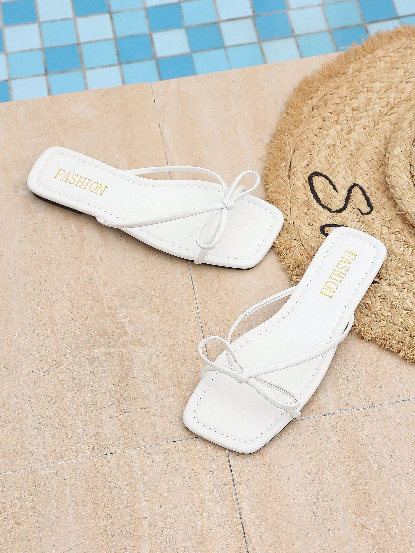 Women’s black flat slip-on sandals with a toe post and striped bow decoration, casual vacation and beach slide style.