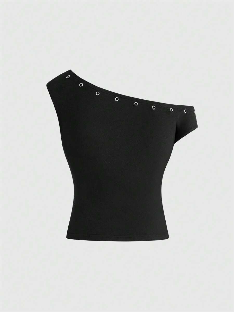 Women's two-piece outfit with an asymmetric neck studded grommet crop top and super low-rise mini shorts