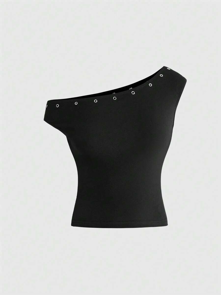 Women's two-piece outfit with an asymmetric neck studded grommet crop top and super low-rise mini shorts