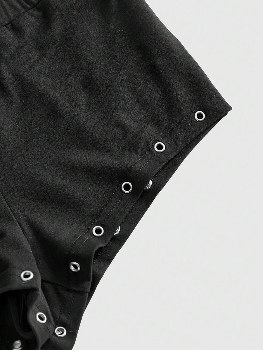 Women's two-piece outfit with an asymmetric neck studded grommet crop top and super low-rise mini shorts