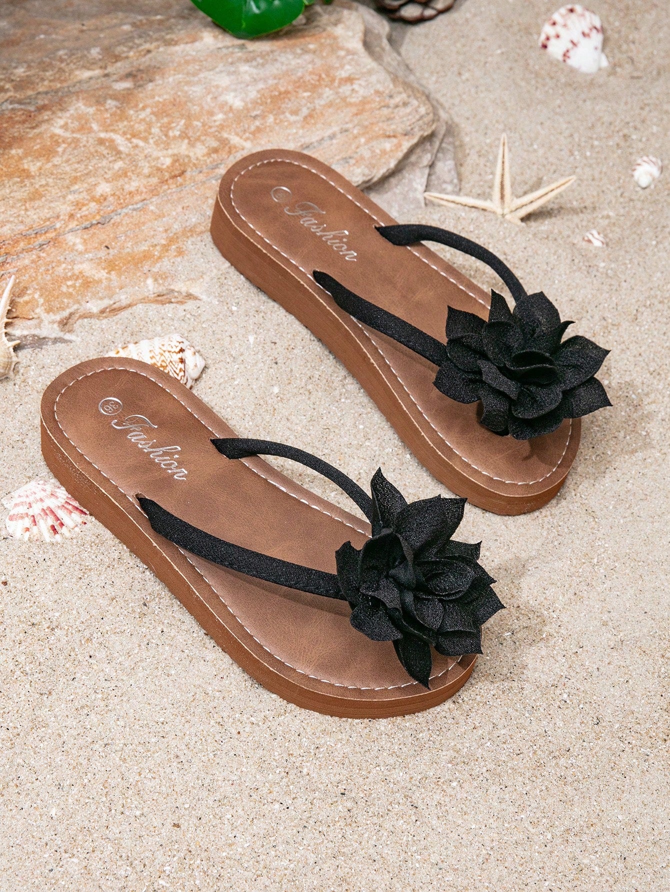 Women's woven-style flat beach flip-flop sandals with black peony applique decoration and casual design