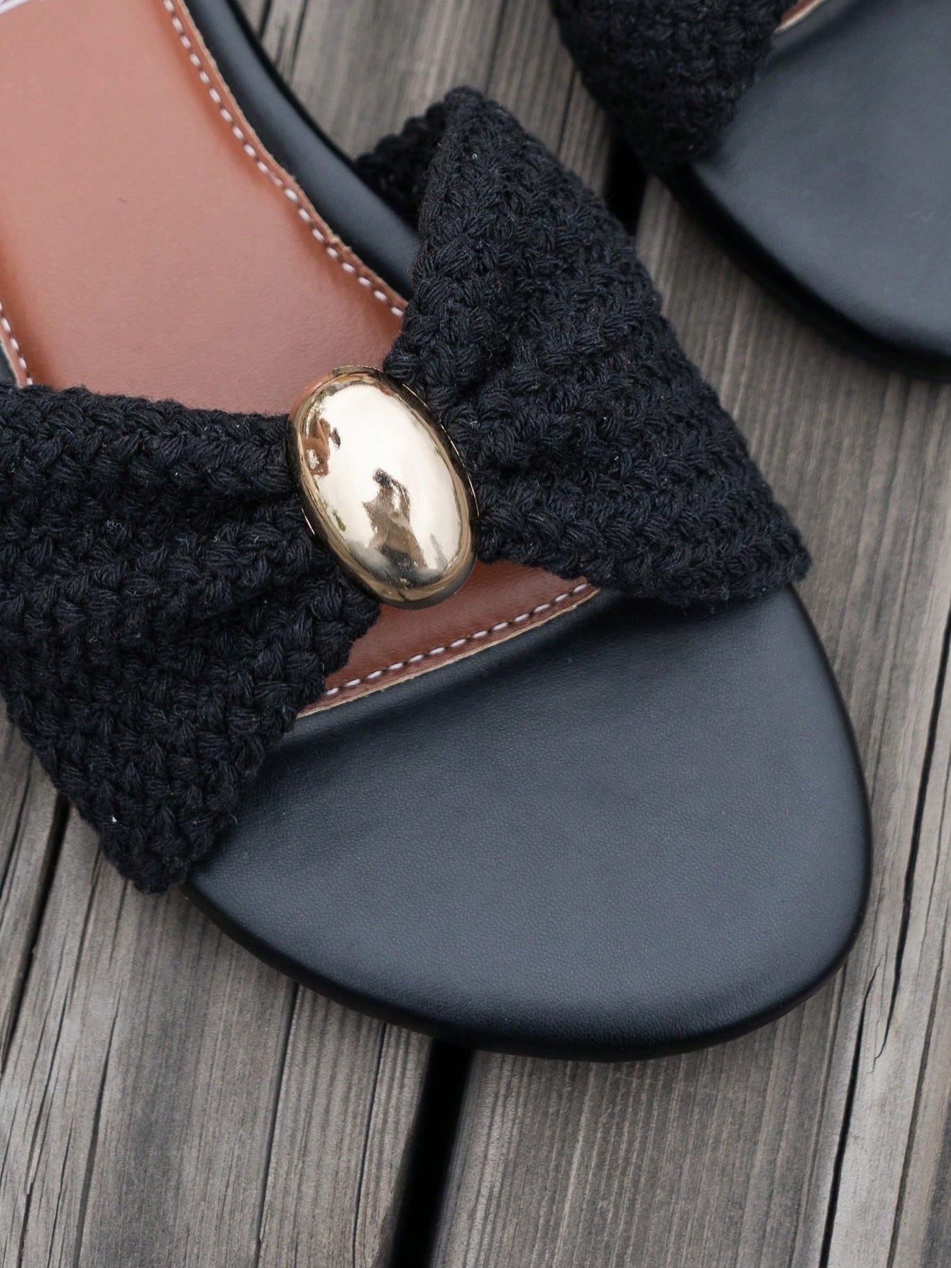 Women's brown straw woven flat slide sandals with bowknot metal decor, braided open-toe strap, and round toe.