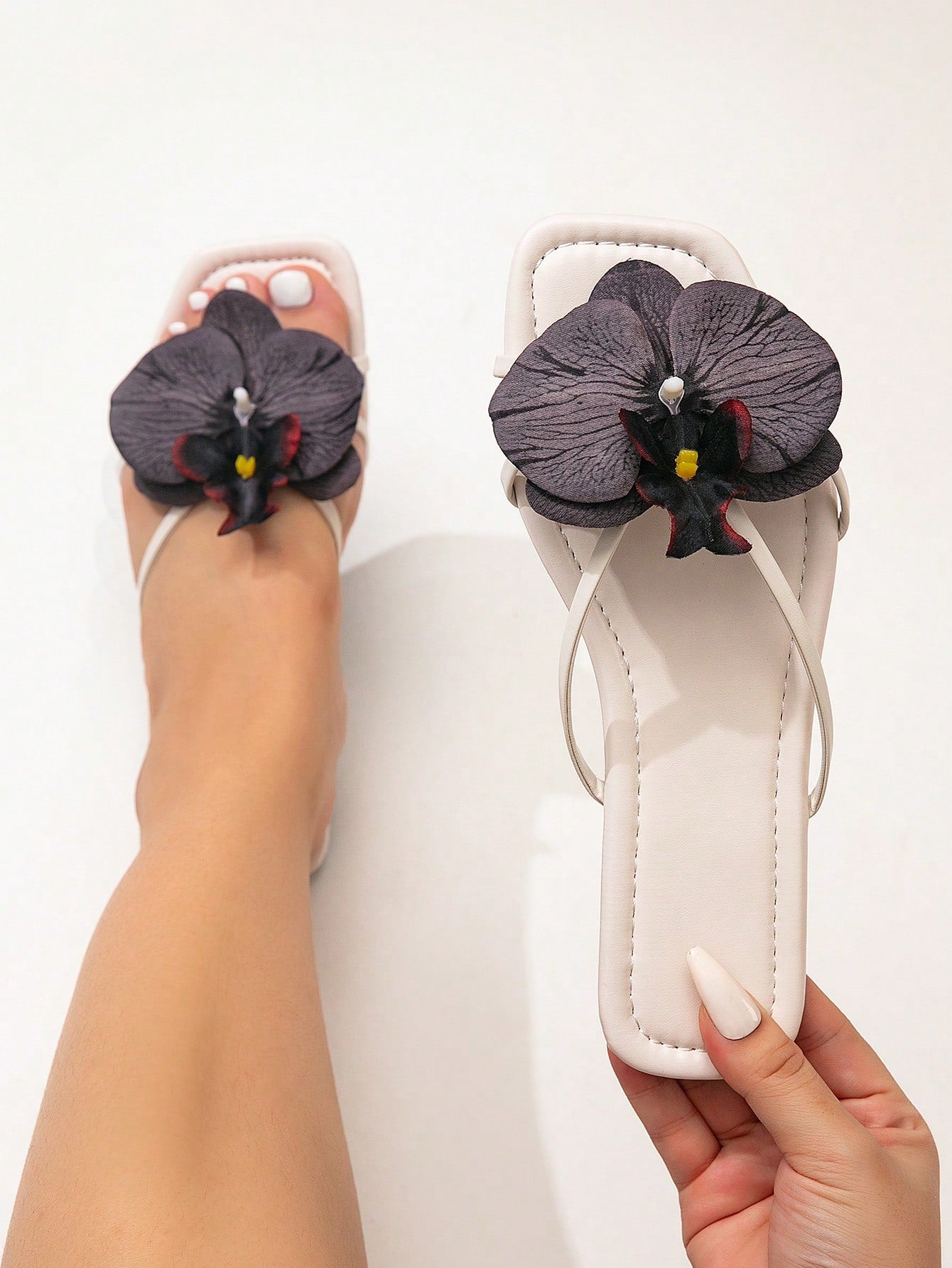 Wide fit women's beige flat thong sandals with butterfly orchid appliqué decor and open toe, suitable for beach, vacation, home, and casual everyday wear.