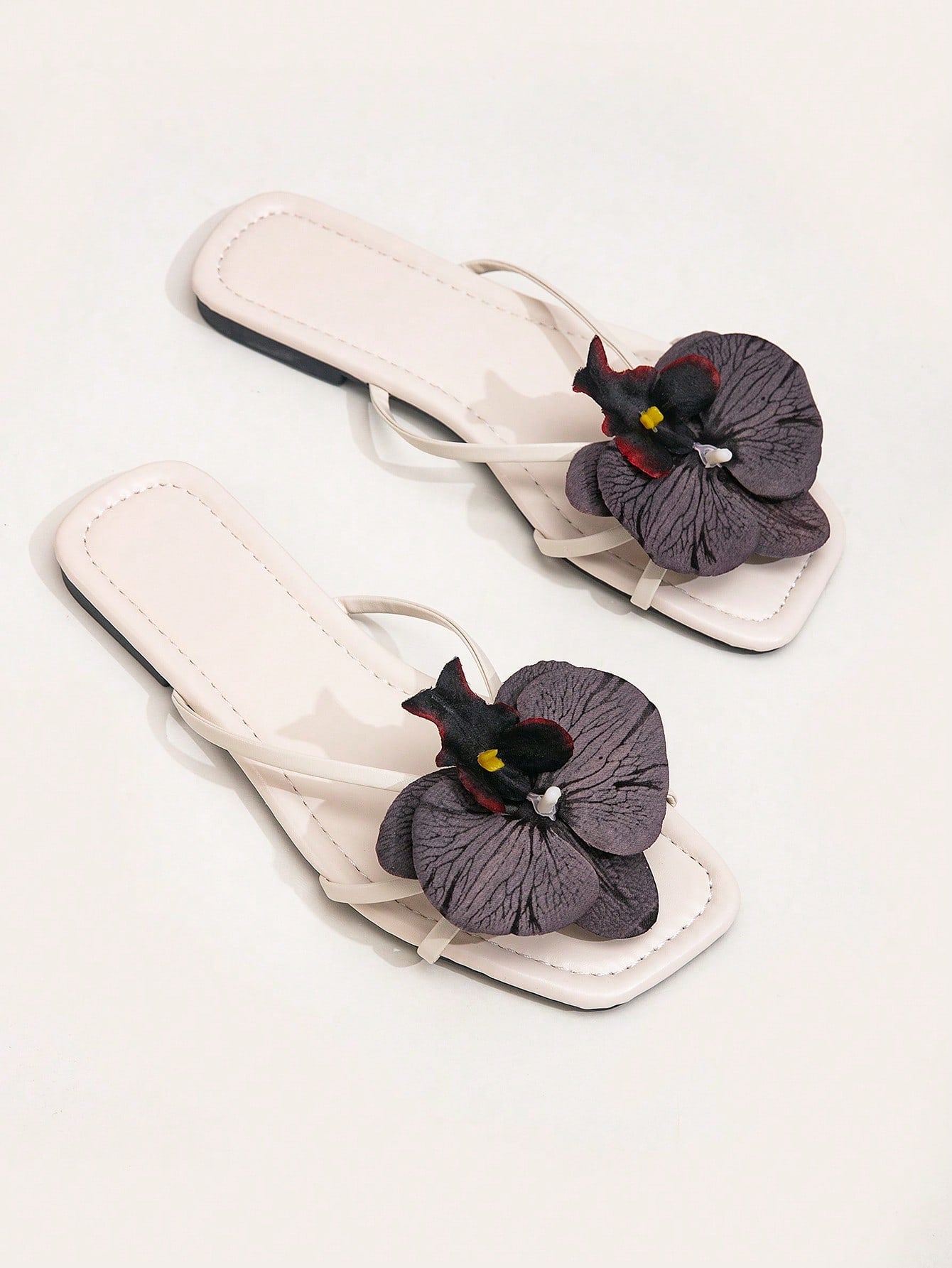Wide fit women's beige flat thong sandals with butterfly orchid appliqué decor and open toe, suitable for beach, vacation, home, and casual everyday wear.