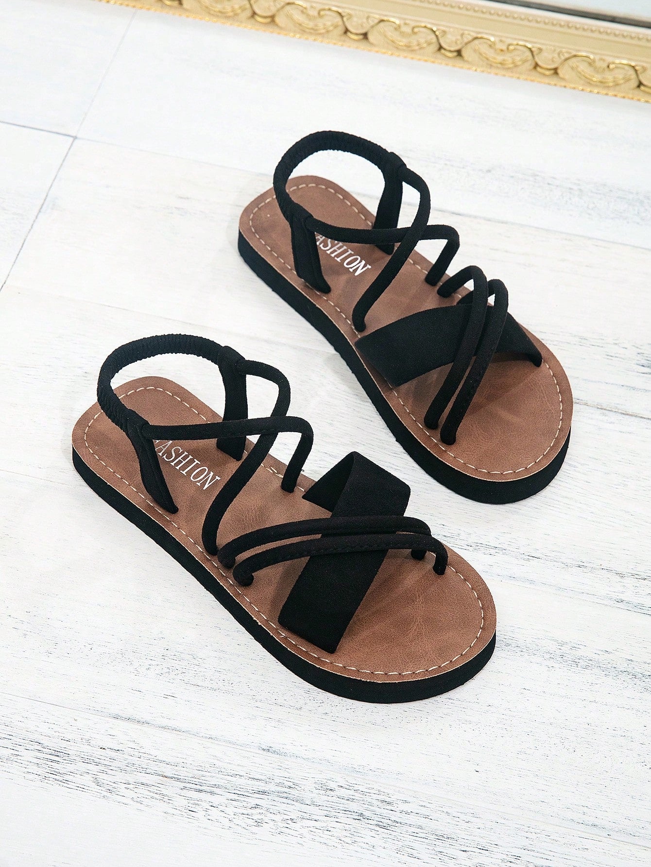 Women's colorblock flat slide sandals with criss cross strap, toe post, cloth tape and fleece detail, finished with sequin, crystal, gemstone, and knot accents.