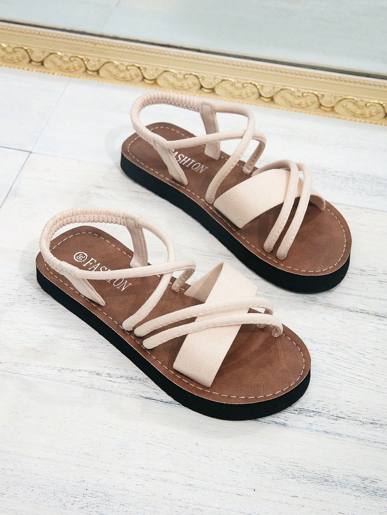 Women's colorblock flat slide sandals with criss cross strap, toe post, cloth tape and fleece detail, finished with sequin, crystal, gemstone, and knot accents.