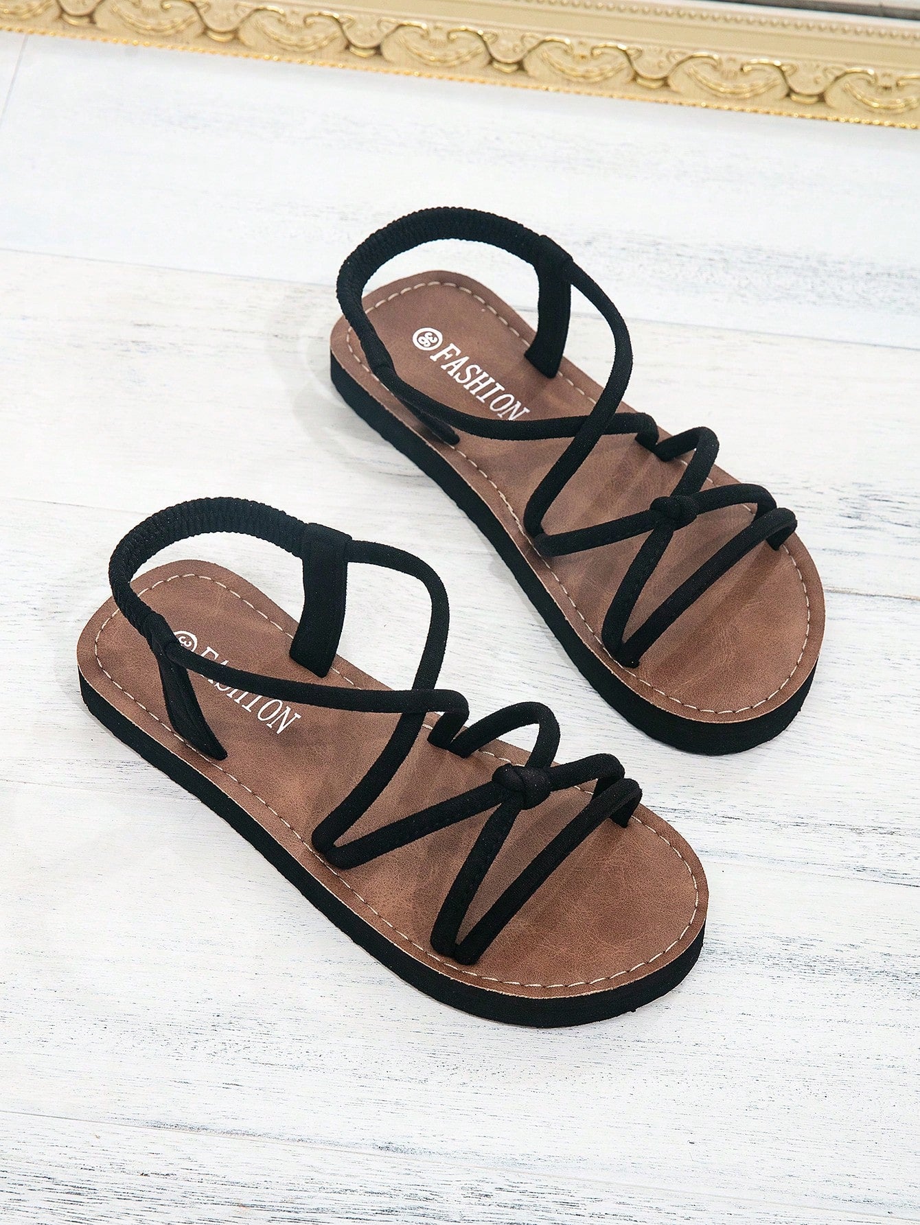Women's colorblock flat slide sandals with criss cross strap, toe post, cloth tape and fleece detail, finished with sequin, crystal, gemstone, and knot accents.