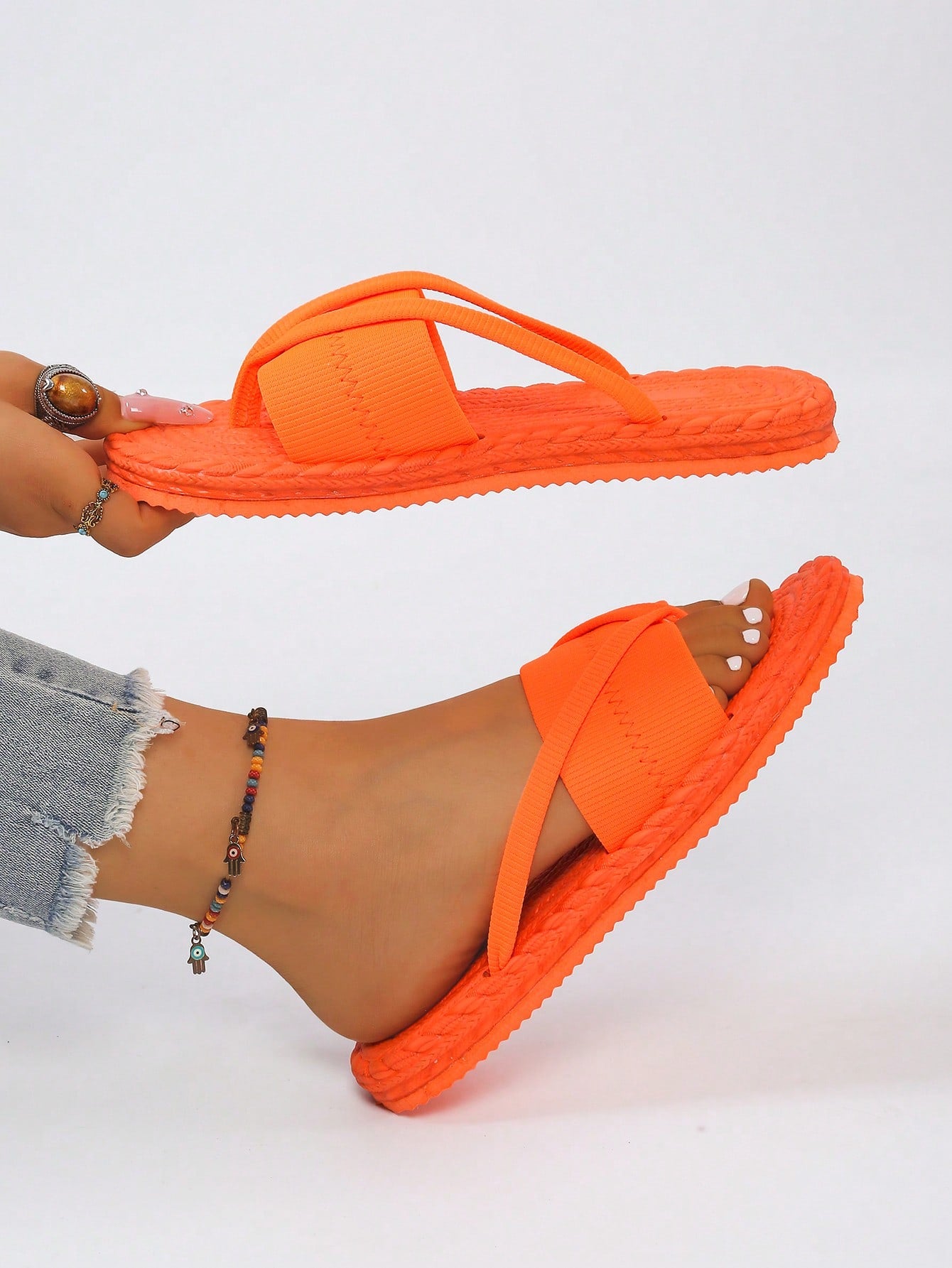 Women's open-toe flat beach sandals with toe ring strap and bow decoration, lightweight slip-on style for vacation and outdoor use.