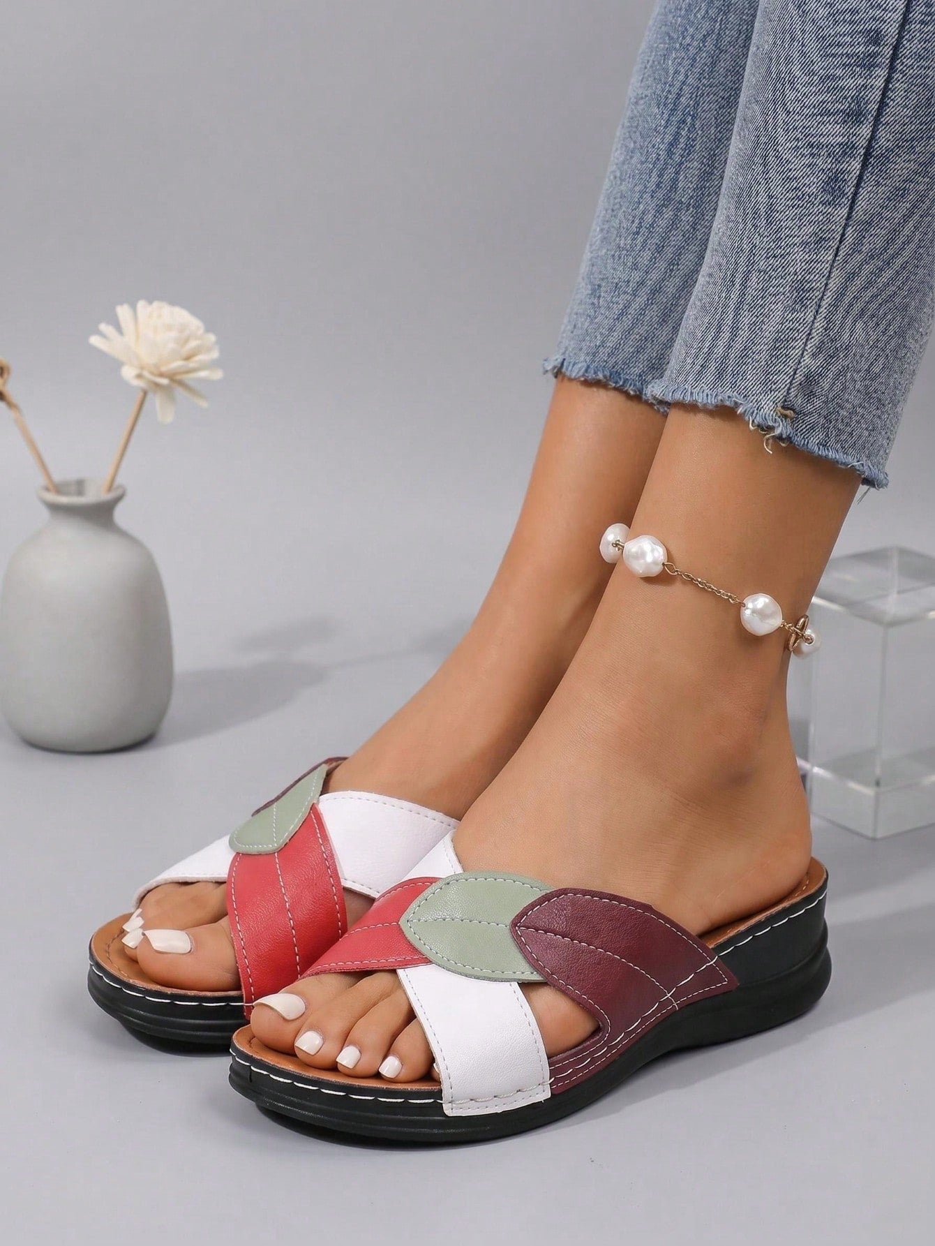 Women's multicolor wedge slide sandals with open toe, criss-cross straps, cut-out details, slip-on closure, and mid chunky wedge heel.