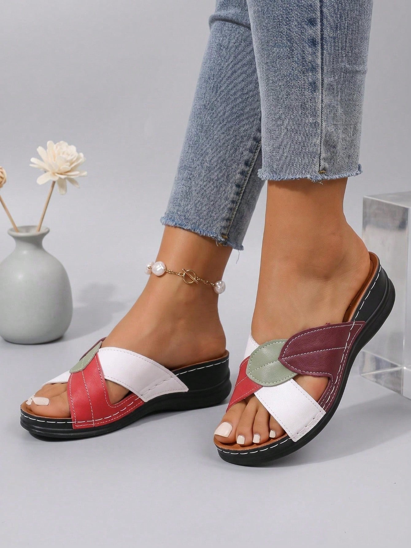 Women's multicolor wedge slide sandals with open toe, criss-cross straps, cut-out details, slip-on closure, and mid chunky wedge heel.