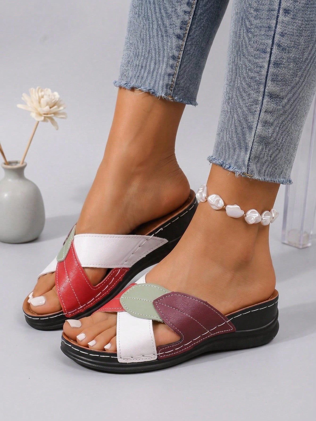 Women's multicolor wedge slide sandals with open toe, criss-cross straps, cut-out details, slip-on closure, and mid chunky wedge heel.