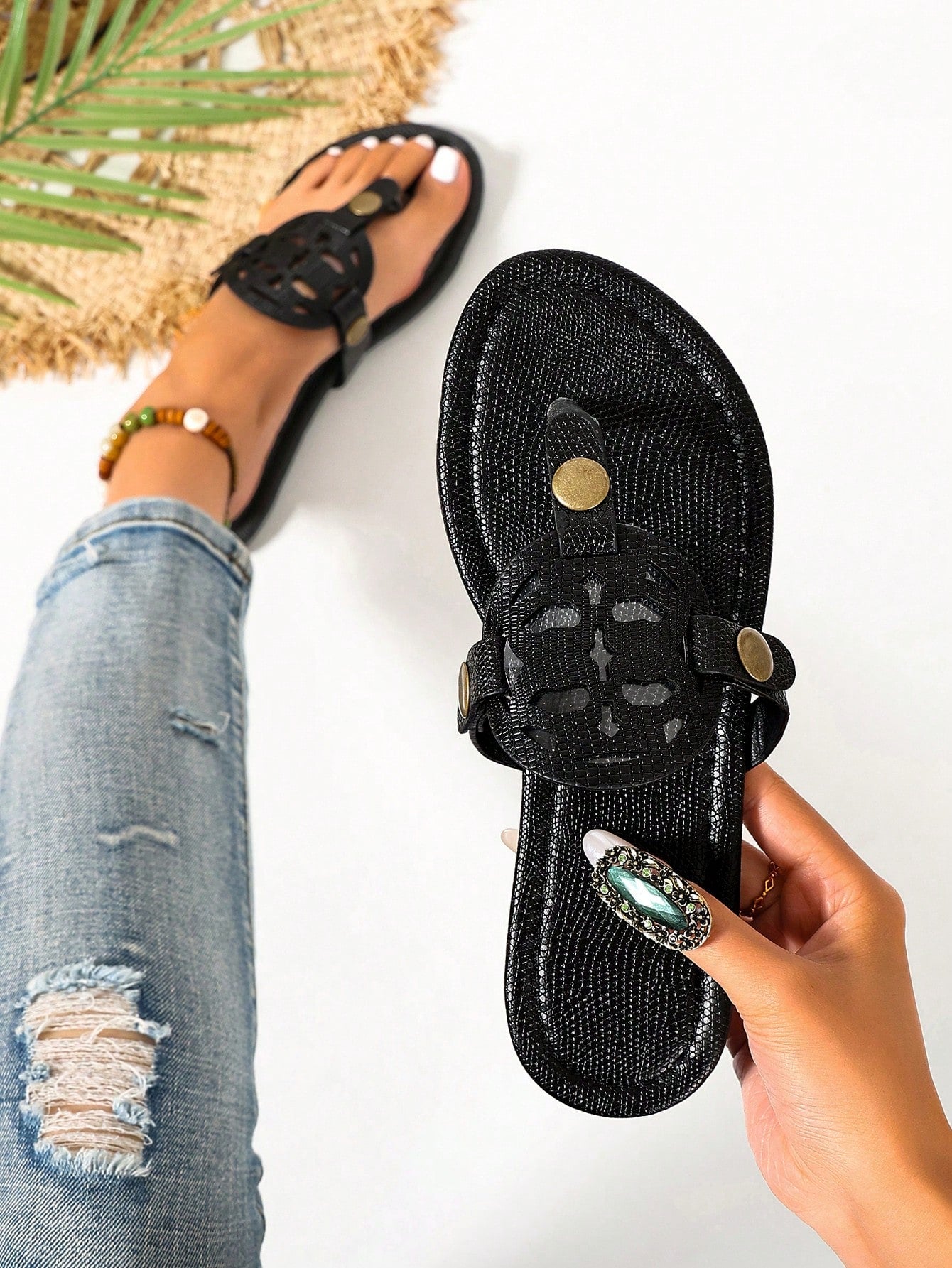 Pair of women’s open-toe flat slide sandals with an H-shaped strap, braided and embossed details, and a minimalist slip-on design suitable for casual outdoor wear.
