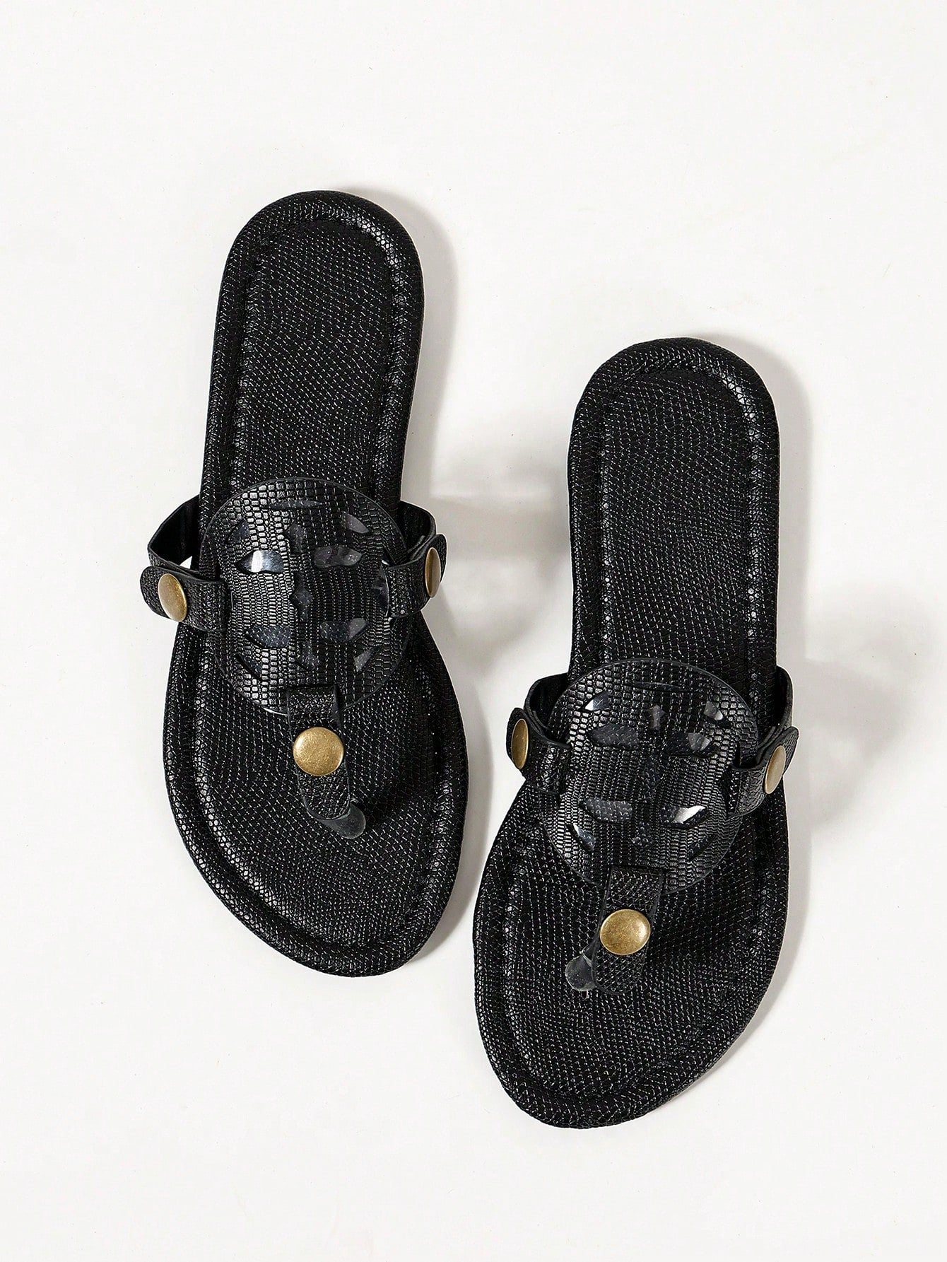 Pair of women’s open-toe flat slide sandals with an H-shaped strap, braided and embossed details, and a minimalist slip-on design suitable for casual outdoor wear.