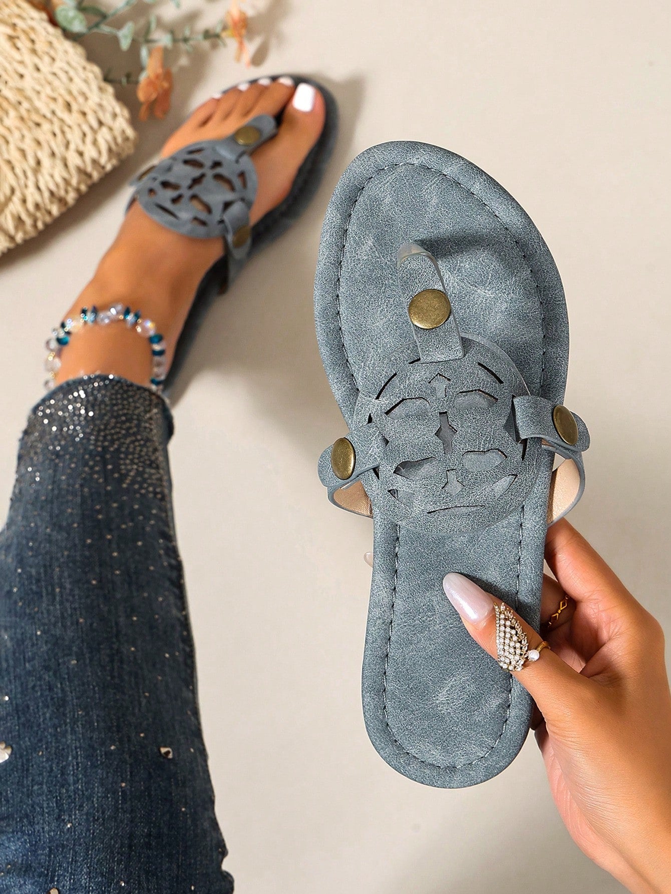 Women’s flat open-toe slide sandals with braided strap detail, embossed texture, and rhinestone decoration, designed as casual slip-on footwear for beach and everyday outdoor wear.