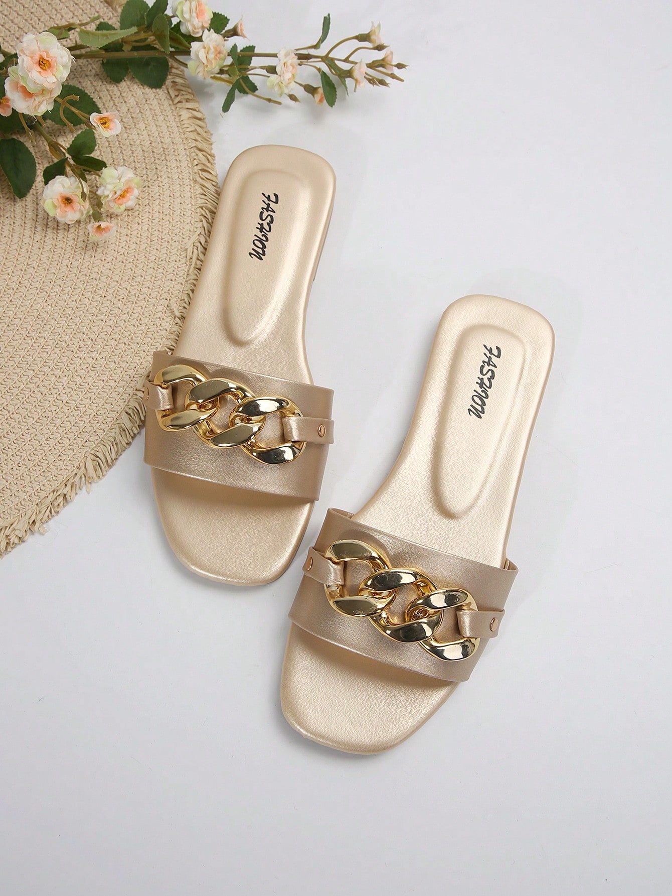 Women's gold-tone slip-on slide sandals with open toe and chain link detailing, shown as casual flat sandals for indoor and outdoor use.