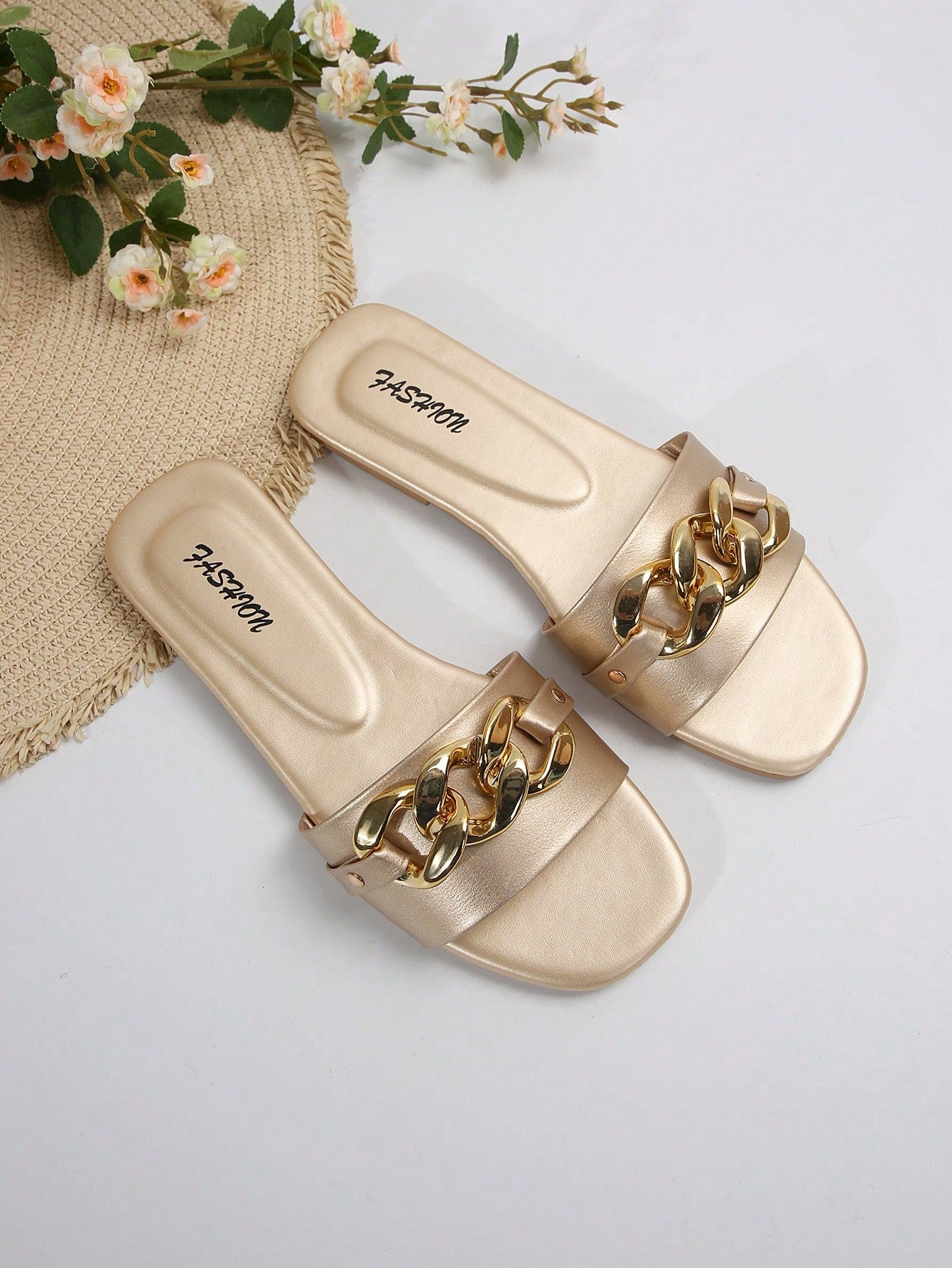 Women's gold-tone slip-on slide sandals with open toe and chain link detailing, shown as casual flat sandals for indoor and outdoor use.