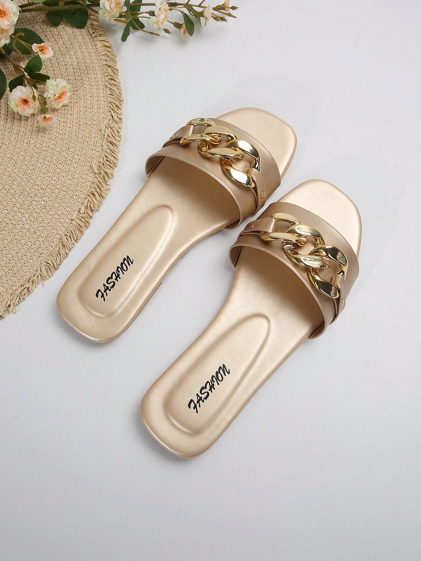 Women's gold-tone slip-on slide sandals with open toe and chain link detailing, shown as casual flat sandals for indoor and outdoor use.