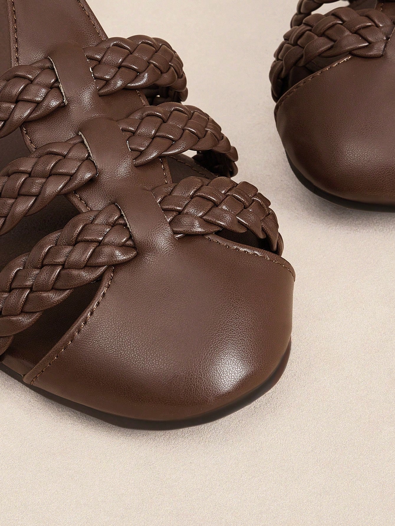 Women's flat gladiator sandals featuring a hollow-out multi-strap woven design and ankle strap style, with striped pattern and casual beach vacation look.
