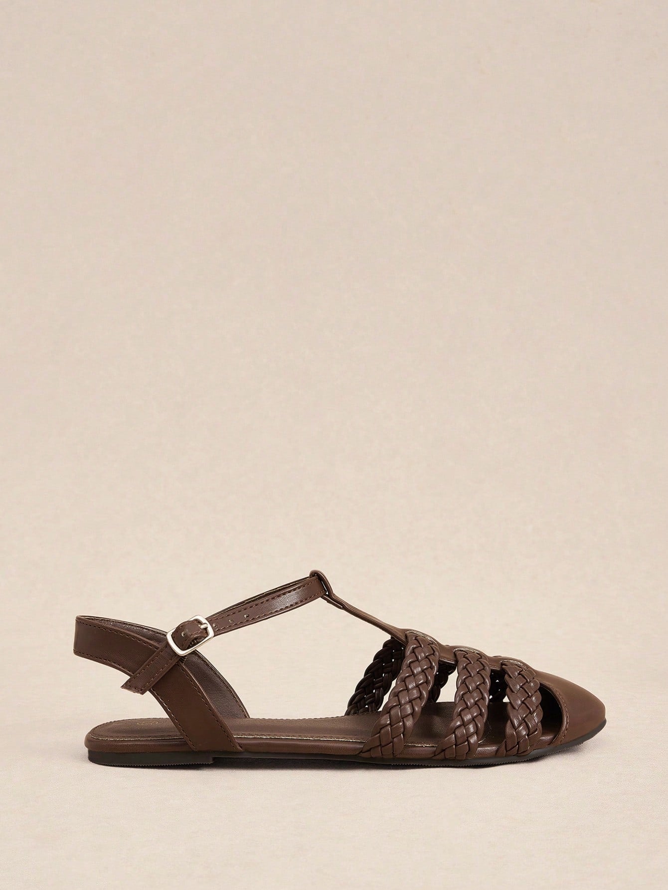 Women's flat gladiator sandals featuring a hollow-out multi-strap woven design and ankle strap style, with striped pattern and casual beach vacation look.