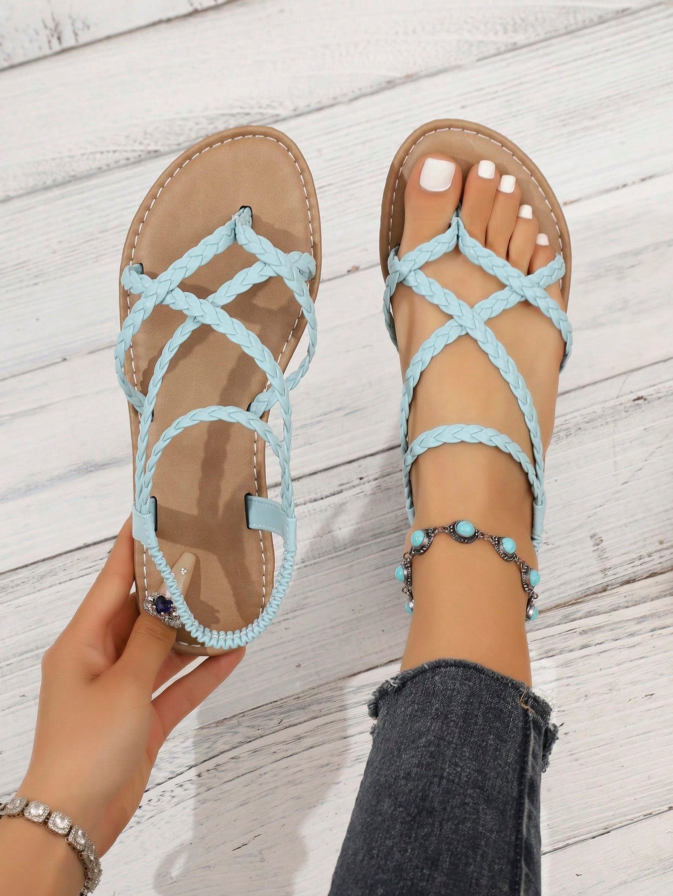 Women's woven criss-cross elastic flat sandals with braided strappy upper and toe post design