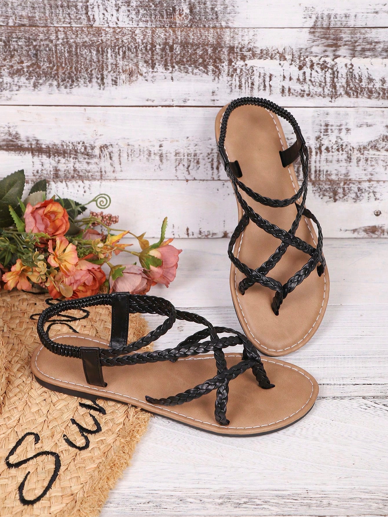 Women's woven criss-cross elastic flat sandals with braided strappy upper and toe post design