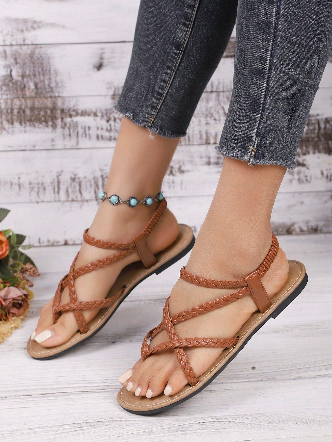 Women's woven criss-cross elastic flat sandals with braided strappy upper and toe post design