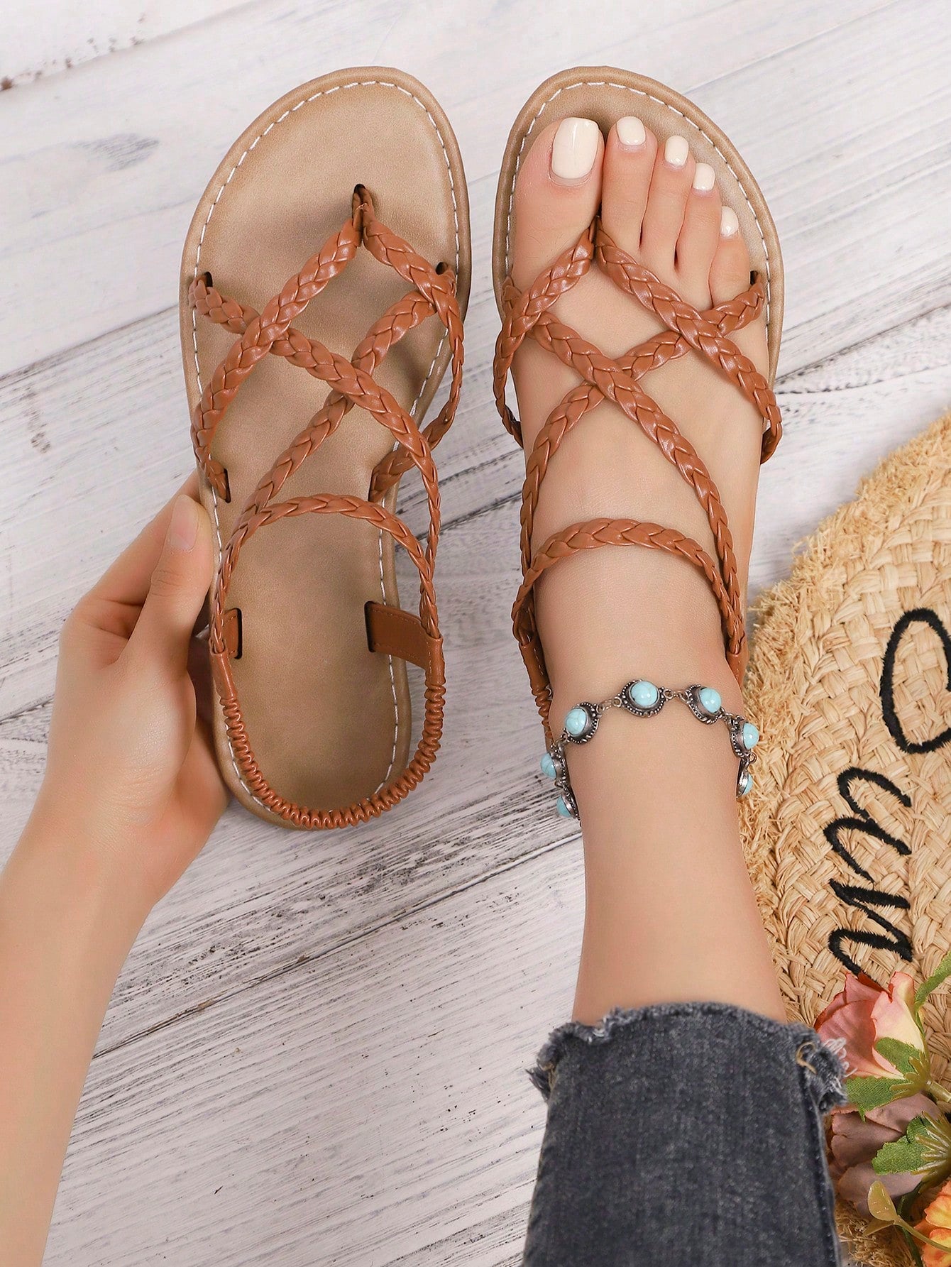 Women's woven criss-cross elastic flat sandals with braided strappy upper and toe post design