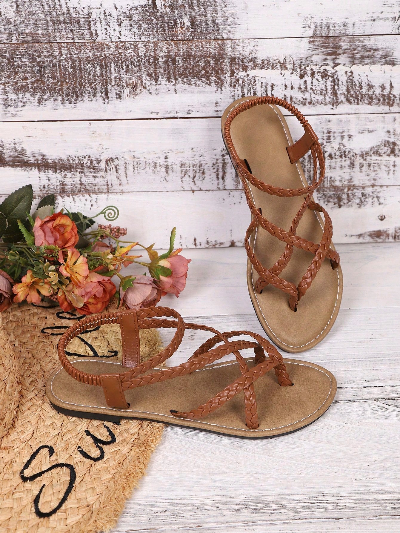Women's woven criss-cross elastic flat sandals with braided strappy upper and toe post design