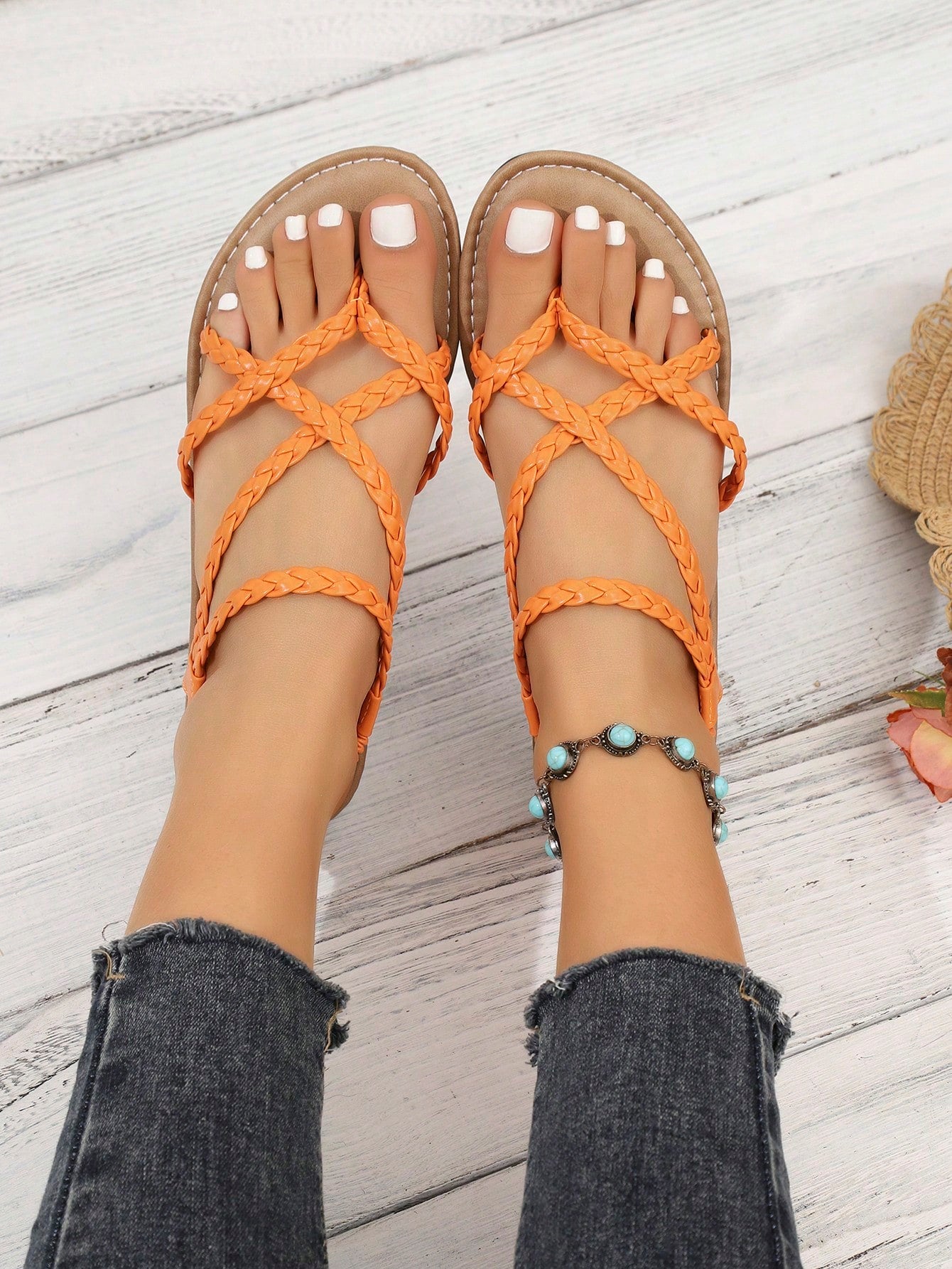 Women's woven criss-cross elastic flat sandals with braided strappy upper and toe post design