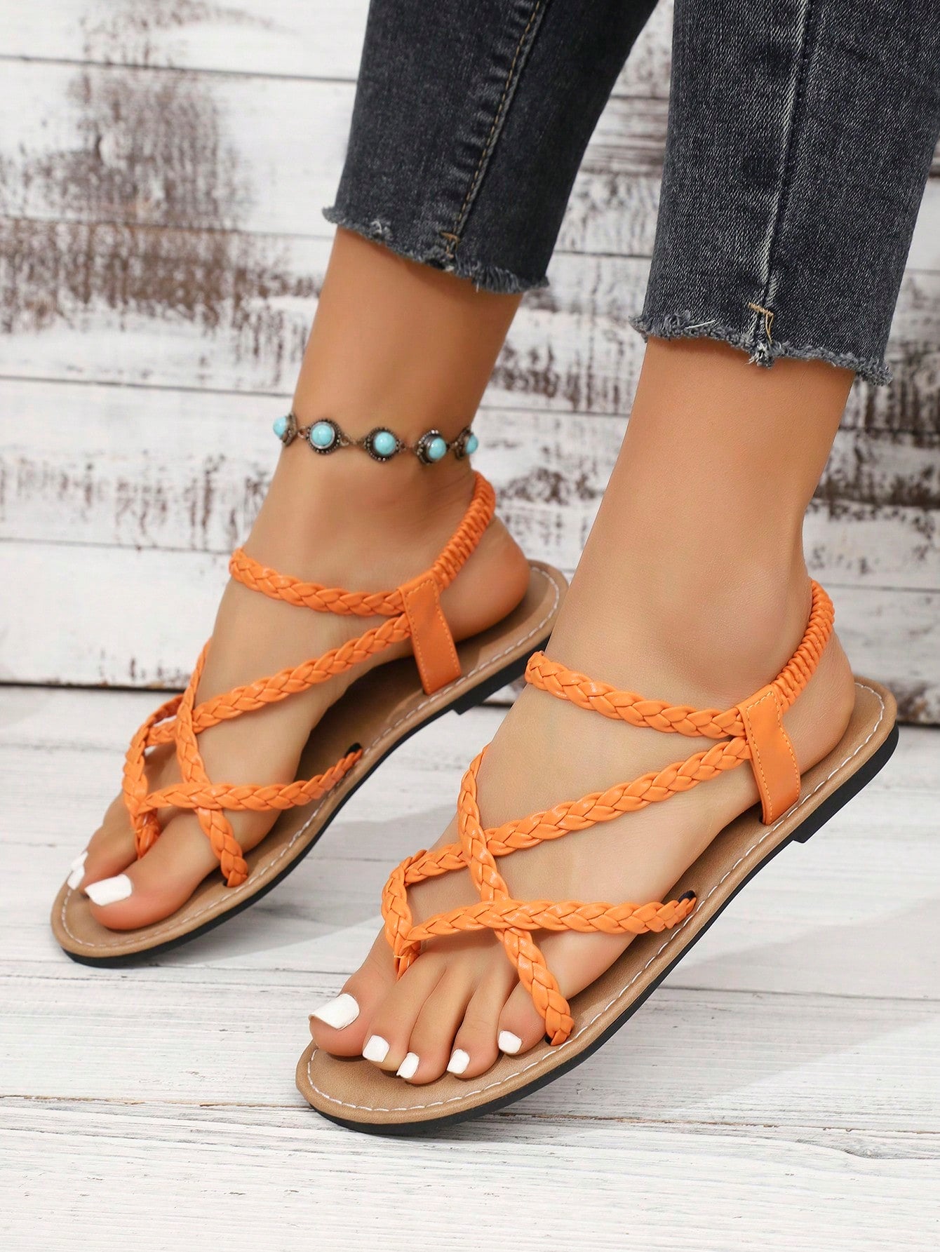 Women's woven criss-cross elastic flat sandals with braided strappy upper and toe post design