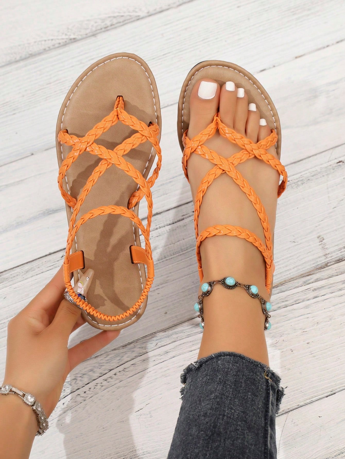 Women's woven criss-cross elastic flat sandals with braided strappy upper and toe post design