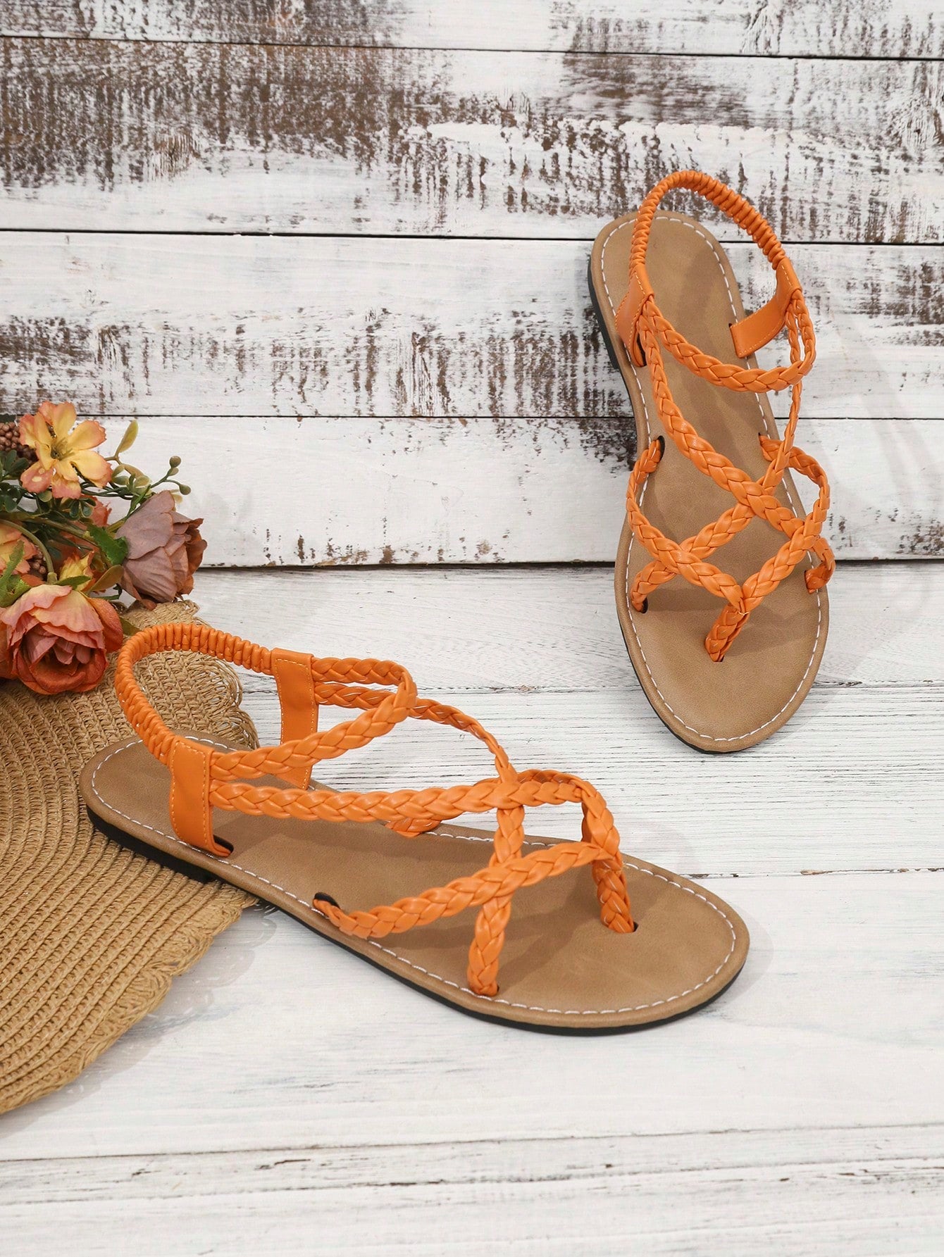 Women's woven criss-cross elastic flat sandals with braided strappy upper and toe post design