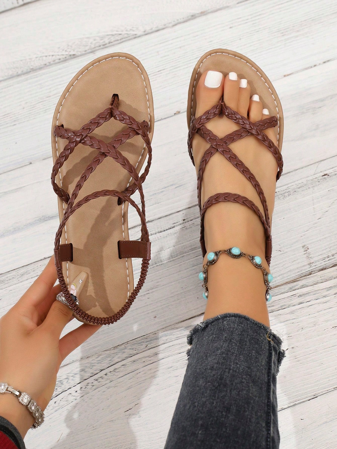 Women's woven criss-cross elastic flat sandals with braided strappy upper and toe post design