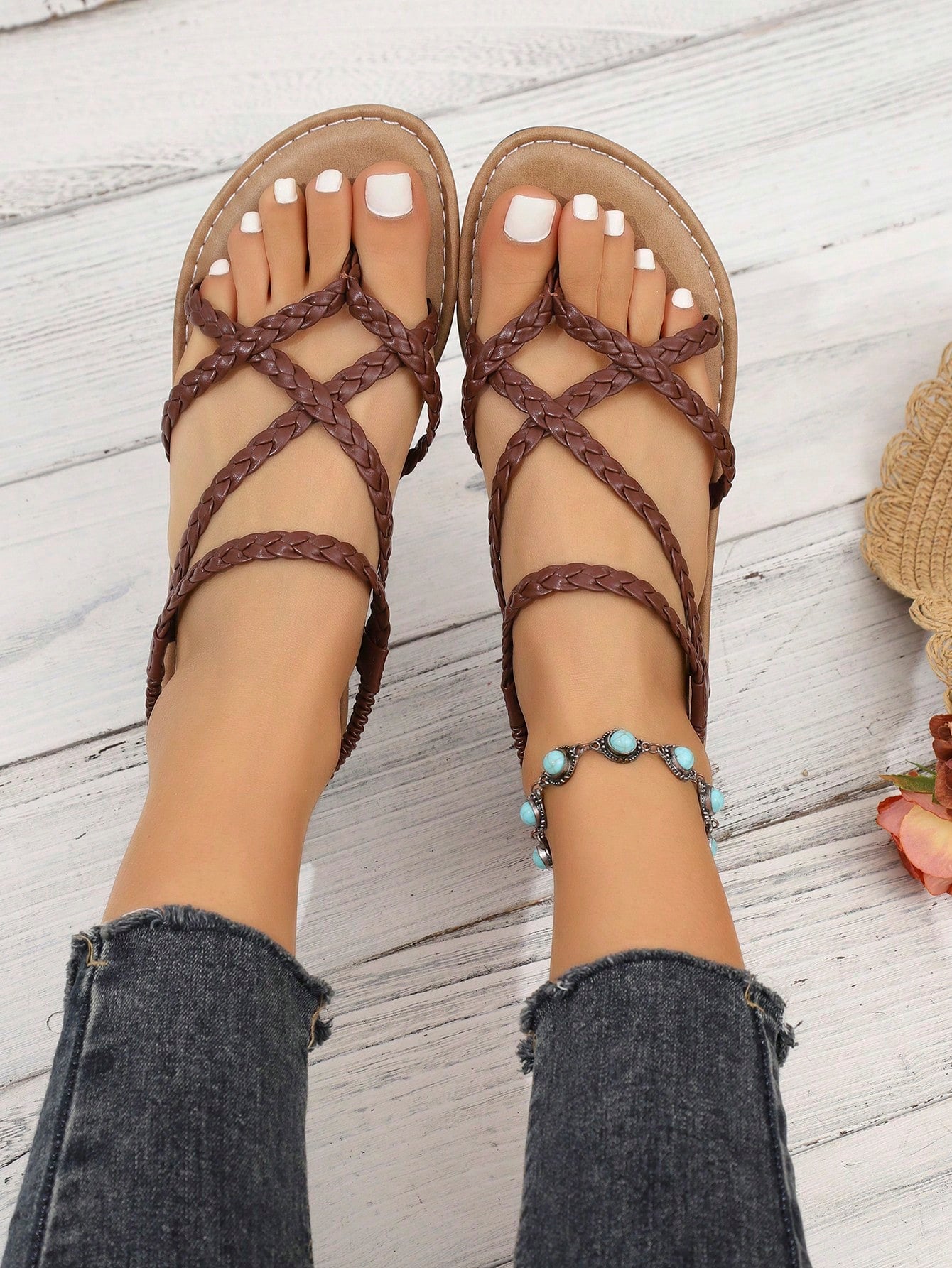 Women's woven criss-cross elastic flat sandals with braided strappy upper and toe post design