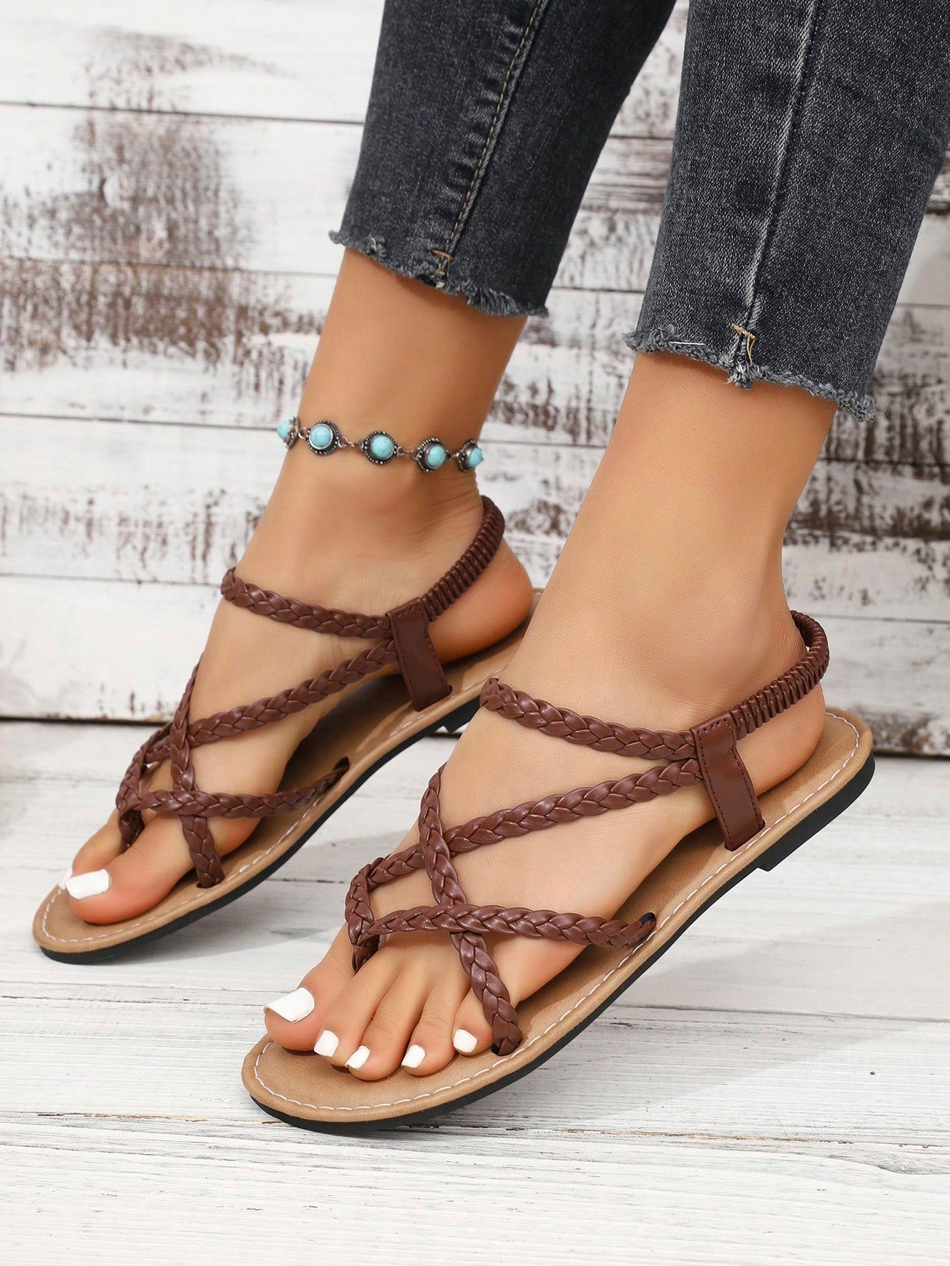 Women's woven criss-cross elastic flat sandals with braided strappy upper and toe post design