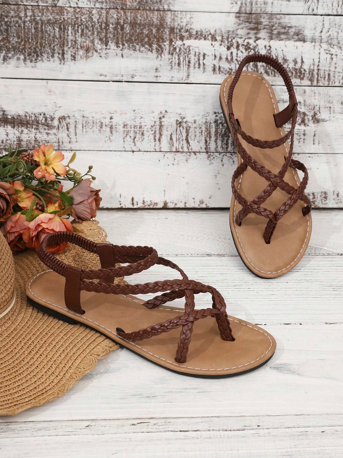 Women's woven criss-cross elastic flat sandals with braided strappy upper and toe post design