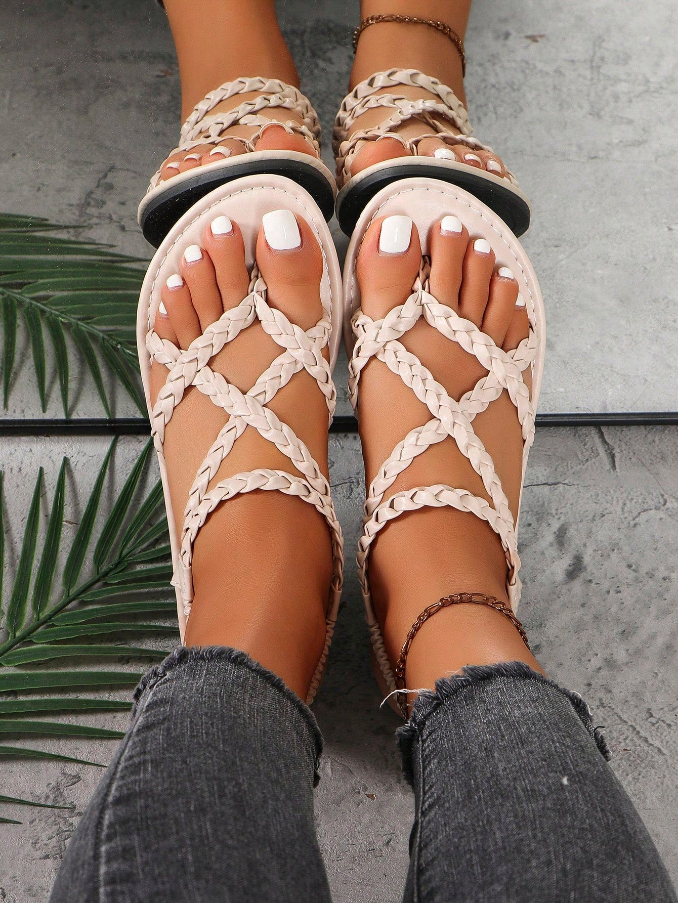 Women's woven criss-cross elastic flat sandals with braided strappy upper and toe post design