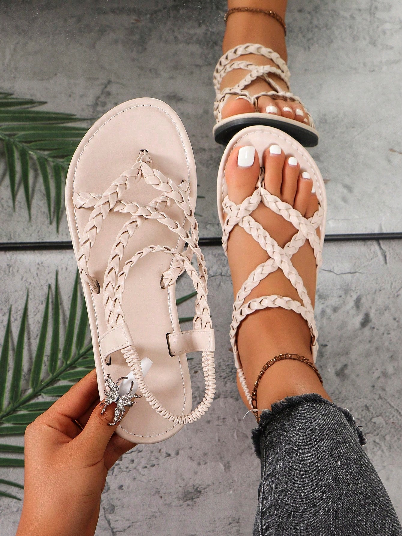 Women's woven criss-cross elastic flat sandals with braided strappy upper and toe post design