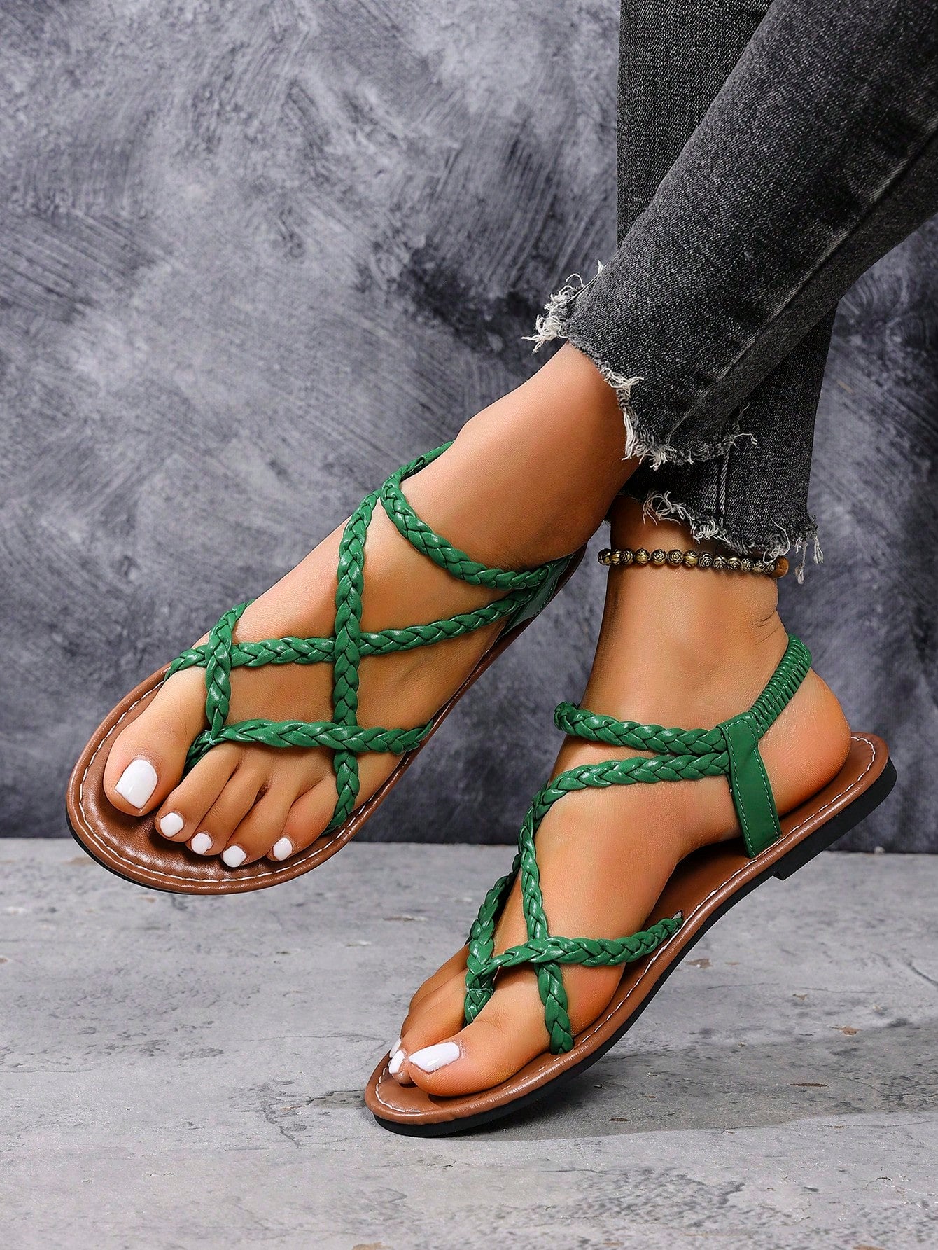 Women's woven criss-cross elastic flat sandals with braided strappy upper and toe post design