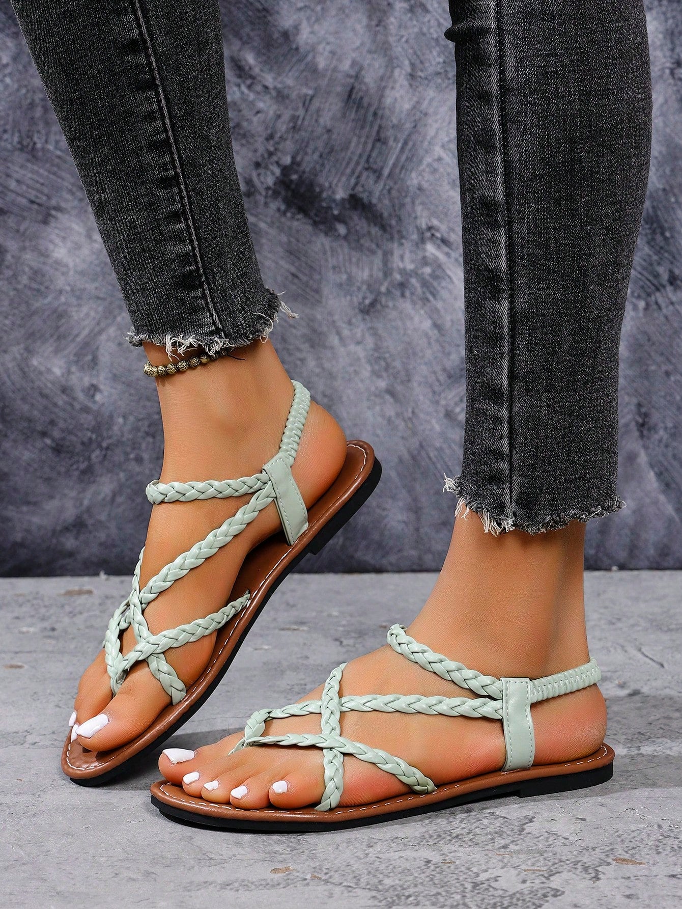 Women's woven criss-cross elastic flat sandals with braided strappy upper and toe post design