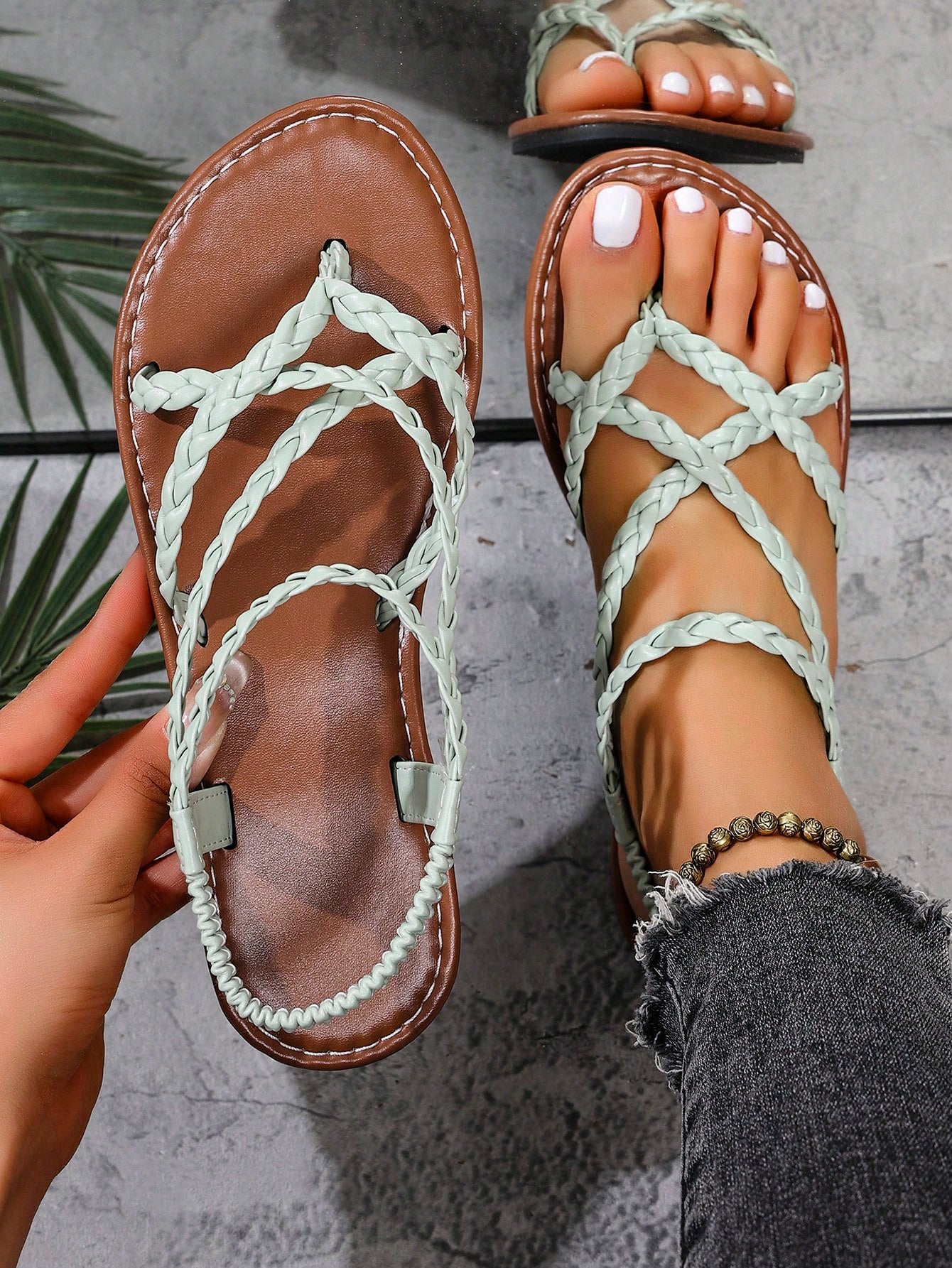 Women's woven criss-cross elastic flat sandals with braided strappy upper and toe post design