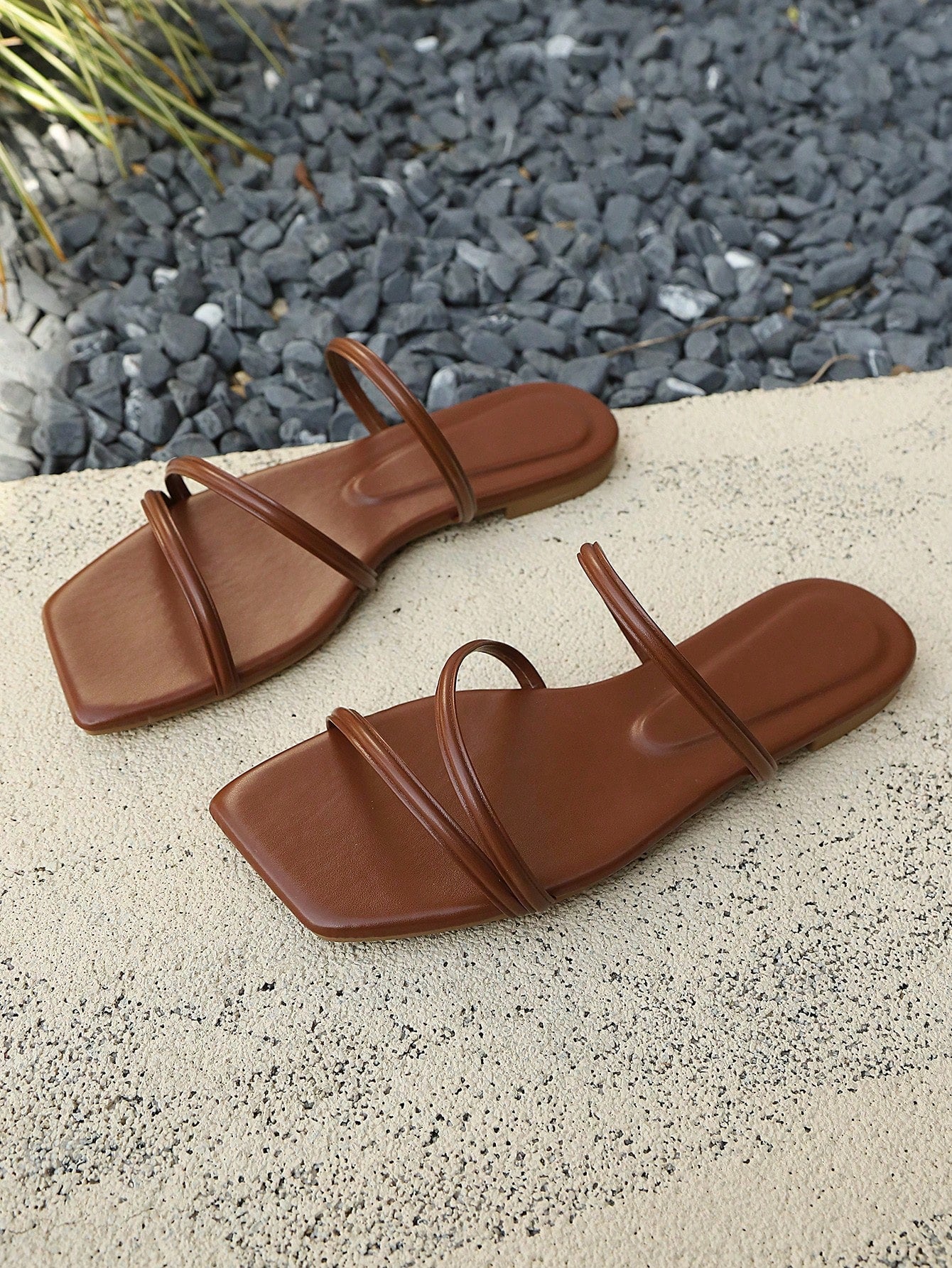 Solid color PU leather flat sandals with criss-cross straps, open toe, and ankle strap design for beach and holiday summer wear.