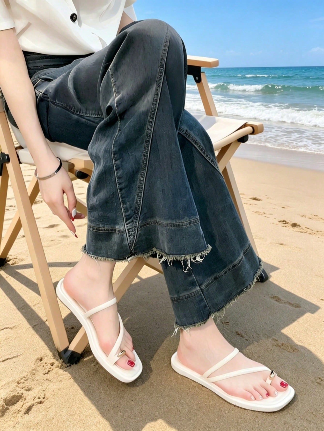 Women's white flat slide sandals featuring criss cross straps, shell detail, and buckle accents