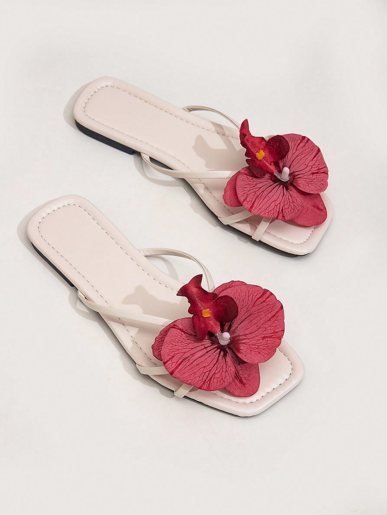 Wide fit women's beige flat thong sandals with butterfly orchid appliqué decor and open toe, suitable for beach, vacation, home, and casual everyday wear.