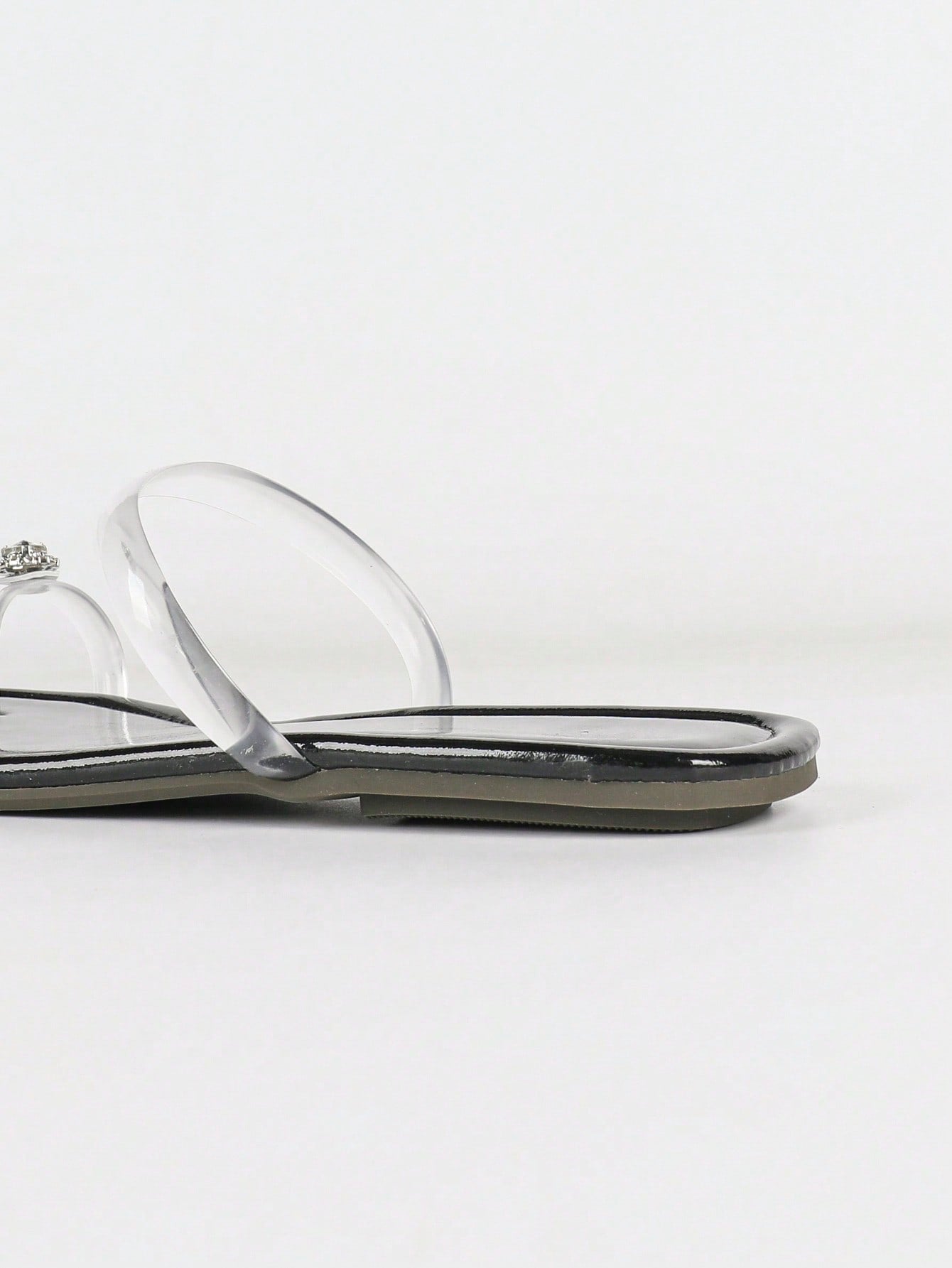 Women's gold flat sandals with metal accent detail, strappy lace-up design, and toe post thong style.