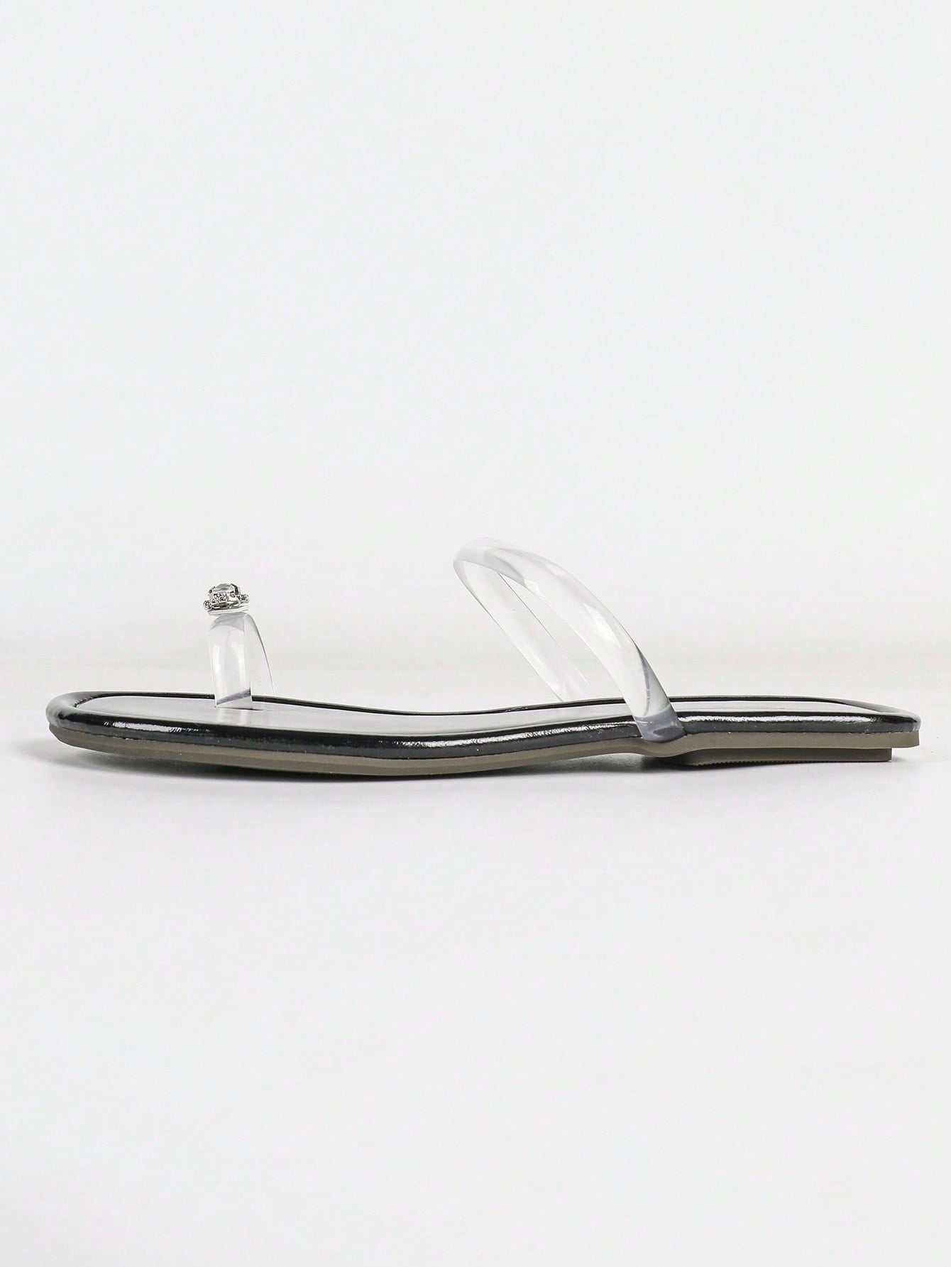 Women's gold flat sandals with metal accent detail, strappy lace-up design, and toe post thong style.